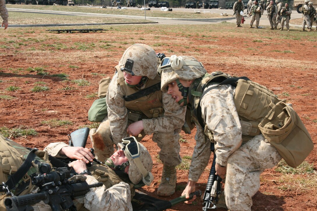 Brigadier General Timothy C. Hanifen, the 2nd Marine Aircraft Wing (Forward) commanding general, pins a Navy and Marine Corps Achievement Medal on Lance Cpl. Kenneth L. Houge, a Cobra team squad leader with Battery B, 2nd Low Altitude Aircraft Defense Battalion, March 12. Houge aided in the recent capture of an insurgent.
