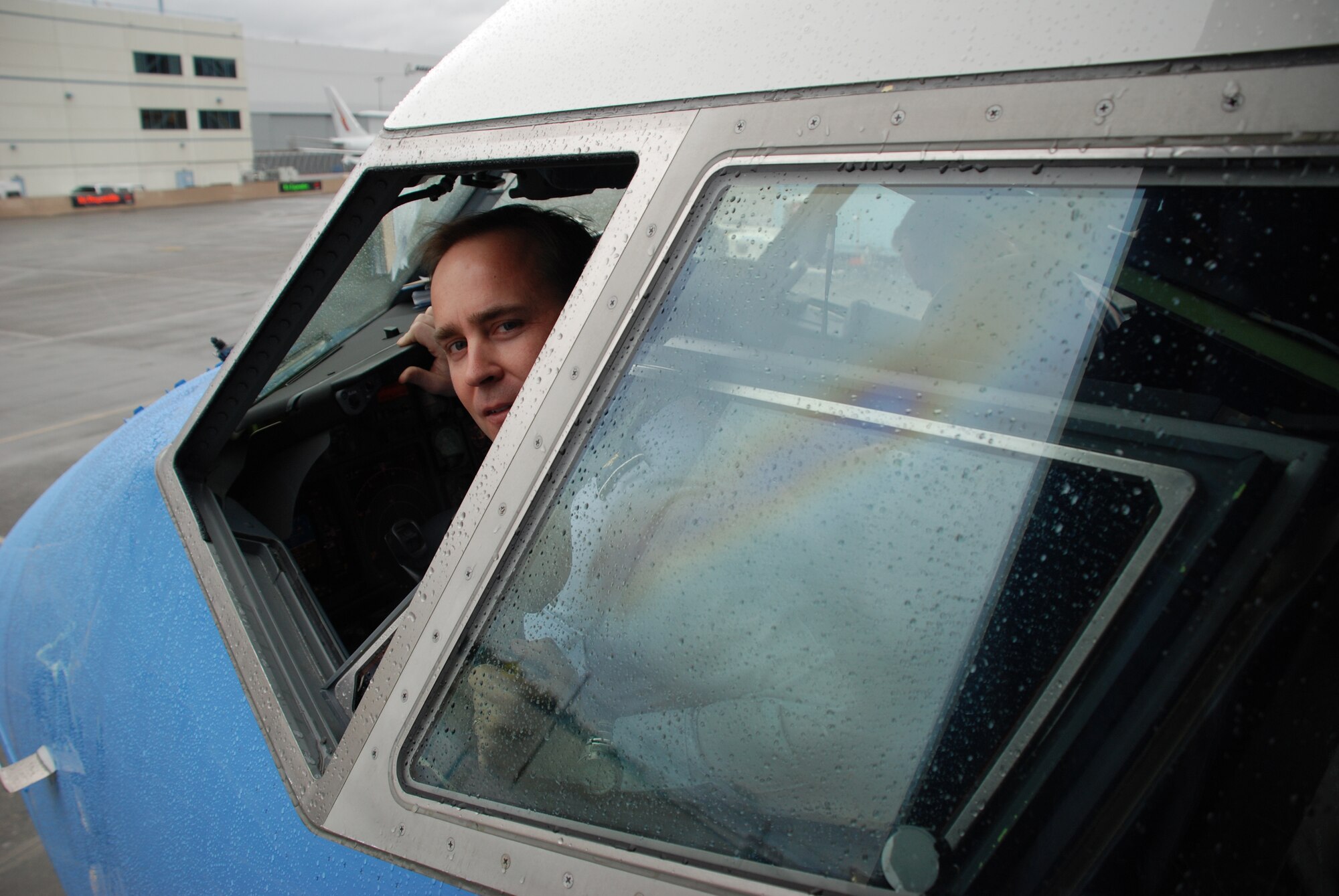 Major Eric Oistad, a 932nd Airlift Wing pilot, gets the cockpit ready for the first customer test flight of the C-40C in Seattle, Washington.  