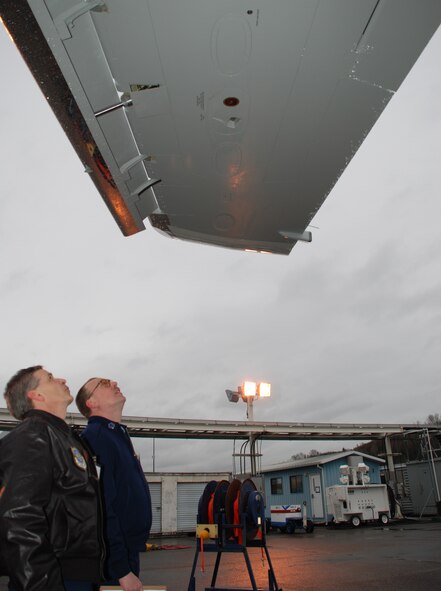 Lt. Col. Paul Brown and Master Sgt. Bob Bode check the wings before flight of the C-40C aircraft in Seattle.