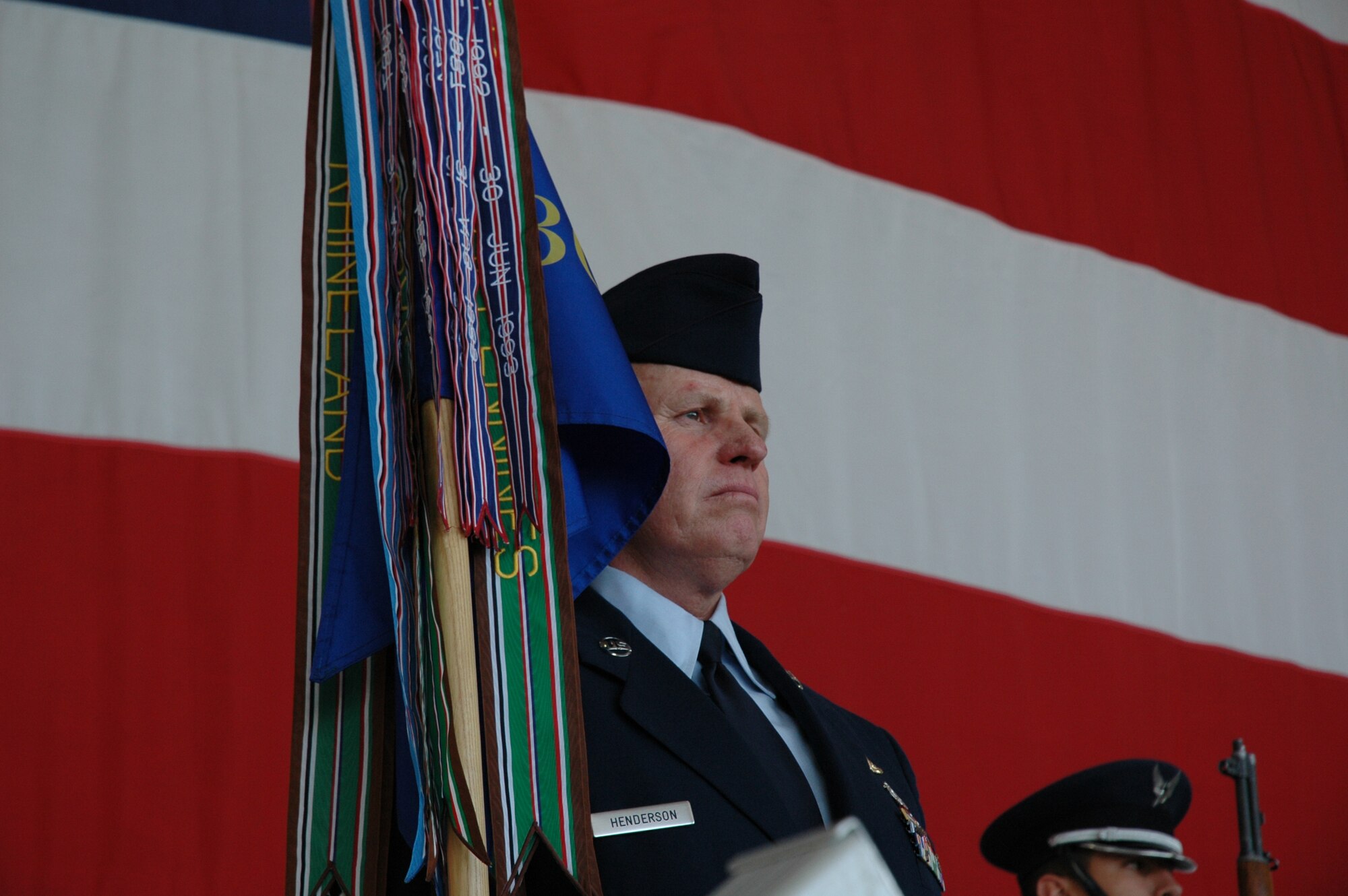 Senior Master Sgt. Buster Henderson, 302nd Fighter Squadron first sergeant, tearfully posts the 302nd FS flag during a symbolic transfer ceremony on March 10, 2007. The 302nd FS, which traces its heritage to the famous Tuskegee Airmen of World War II, will begin a new chapter in its long history as it becomes a reserve associate F-22 squadron at Elmendorf Air Force Base, Alaska. (U.S. Air Force photo/Staff Sgt. Susan Stout)