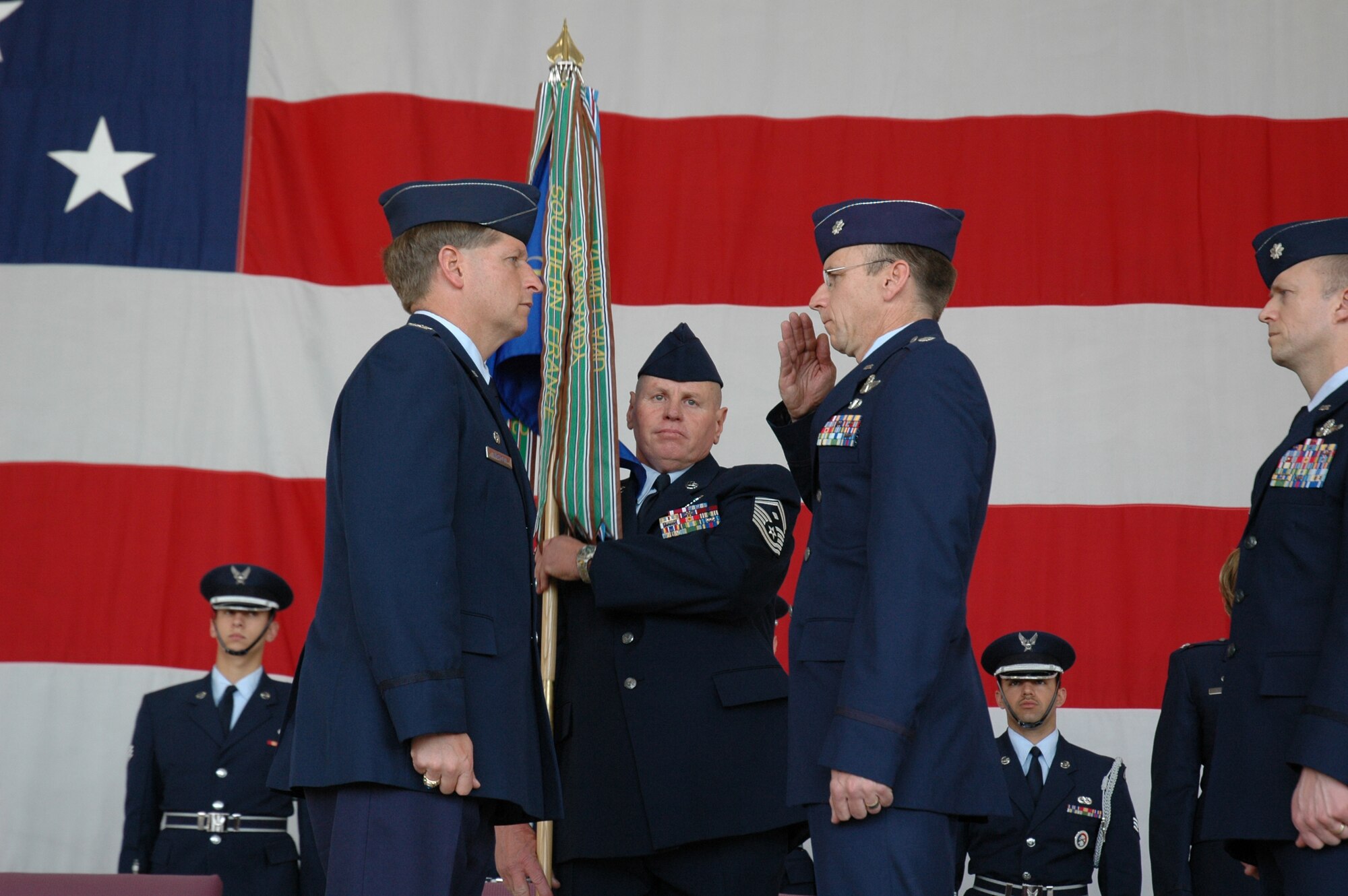 Col. Derek Rydholm, 944th Fighter Wing commander, listens as Lt. Col. Donald Lindberg, 302nd Fighter Squadron commander, symbolically relinquishes command of the squadron during a transfer ceremony March 10, 2007. The 302nd Fighter Squadron will become the first and only reserve associate F-22 squadron. The tradition, started by the Tuskegee Airmen in 1942, will live on as the squadron takes on the mission of flying the newest and greatest fighter aircraft. (U.S. Air Force photo/Staff Sgt. Susan Stout)