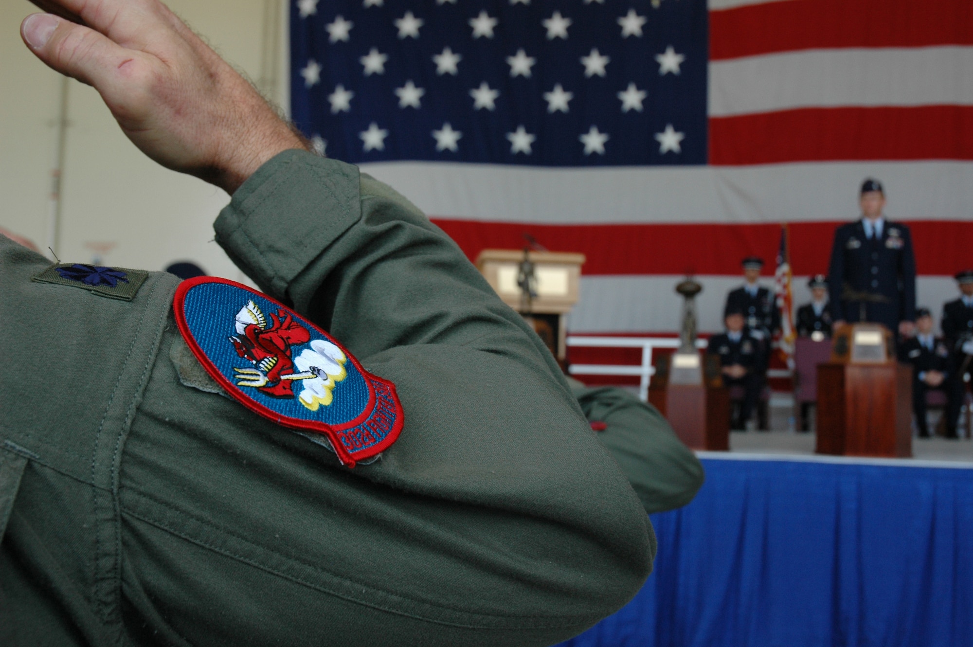 A 302nd Fighter Squadron pilot salutes in honor of the flag transfer during a ceremony at Luke Air Force Base, Ariz., on March 10, 2007. The 302nd Fighter Squadron, which was activated on Oct. 13, 1942, was originally assigned to the 332nd Fighter Group, better known as the Tuskegee Airmen. Though still segregated by the Army, white American bomber crews learned to appreciate and respect the Tuskegee Airmen, referring to them as the "Redtail Angels." This reference was due to the identifying red pain on their nose and tail assemblies and their reputation for not losing any bombers to enemy fighters as they provided fighter escort to bombing missions over Europe. (U.S. Air Force photo/Staff Sgt. Susan Stout)