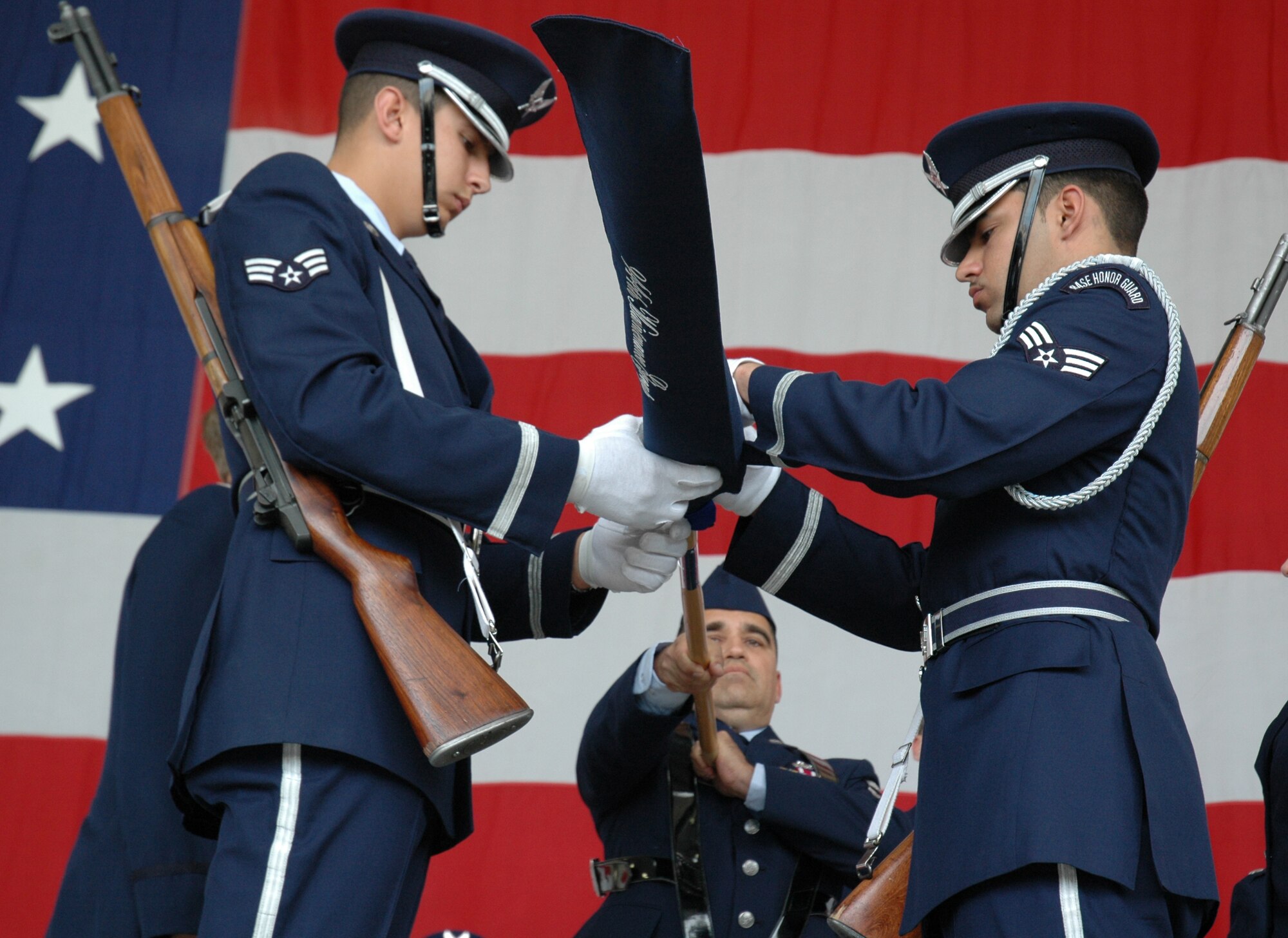 Members of the 944th Fighter Wing Honor Guard furl the 944th Maintenance Group flag, held by Chief Master Sgt. Pablo Valverde, during a symbolic deactivation ceremony on March 10, 2007. The 944th Maintenance Group's positions are being cut as a result of Base Realignment and Closure recommendations which reassigned the wing's 17 F-16s to various locations. (U.S. Air Force photo/Staff Sgt. Susan Stout)