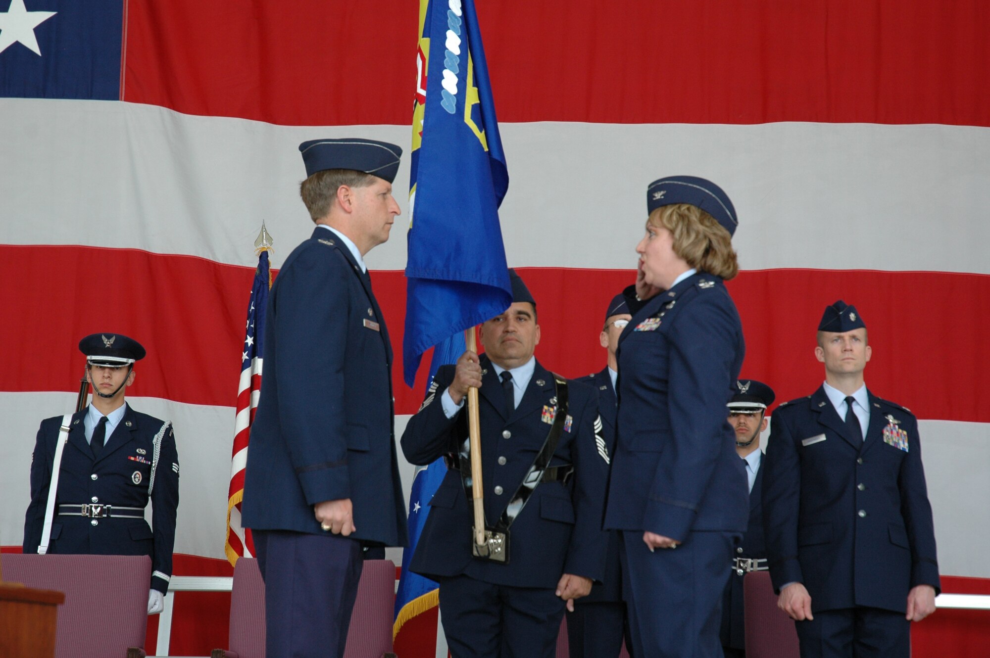 Col. Linda McCourt (right) relinquishes command of the 944th Maintenance Group to Col. Derek Rydholm, 944th Fighter Wing commander, during a symbolic deactivation ceremony March 10, 2007. The 944th Maintenance Group has been at Luke Air Force Base for nearly 20 years and during that time has received numerous accolades including the highest grade ever given to an Air Force Reserve Command unit during the 2005 Maintenance Standardization and Evaluation Program Inspection. (U.S. Air Force photo/Staff Sgt. Susan Stout)