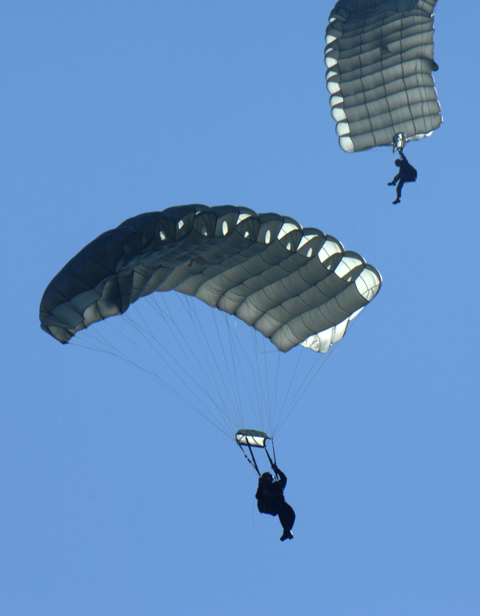 MOODY AIR FORCE BASE, Ga. --  Two parachutists descend towards their landing zone after jumping from a Moody HC-130P. Jumpers are required to jump at least four times a year to maintain their qualifications.  (U.S. Air Force photo by Airman 1st Class Gina Chiaveratti)