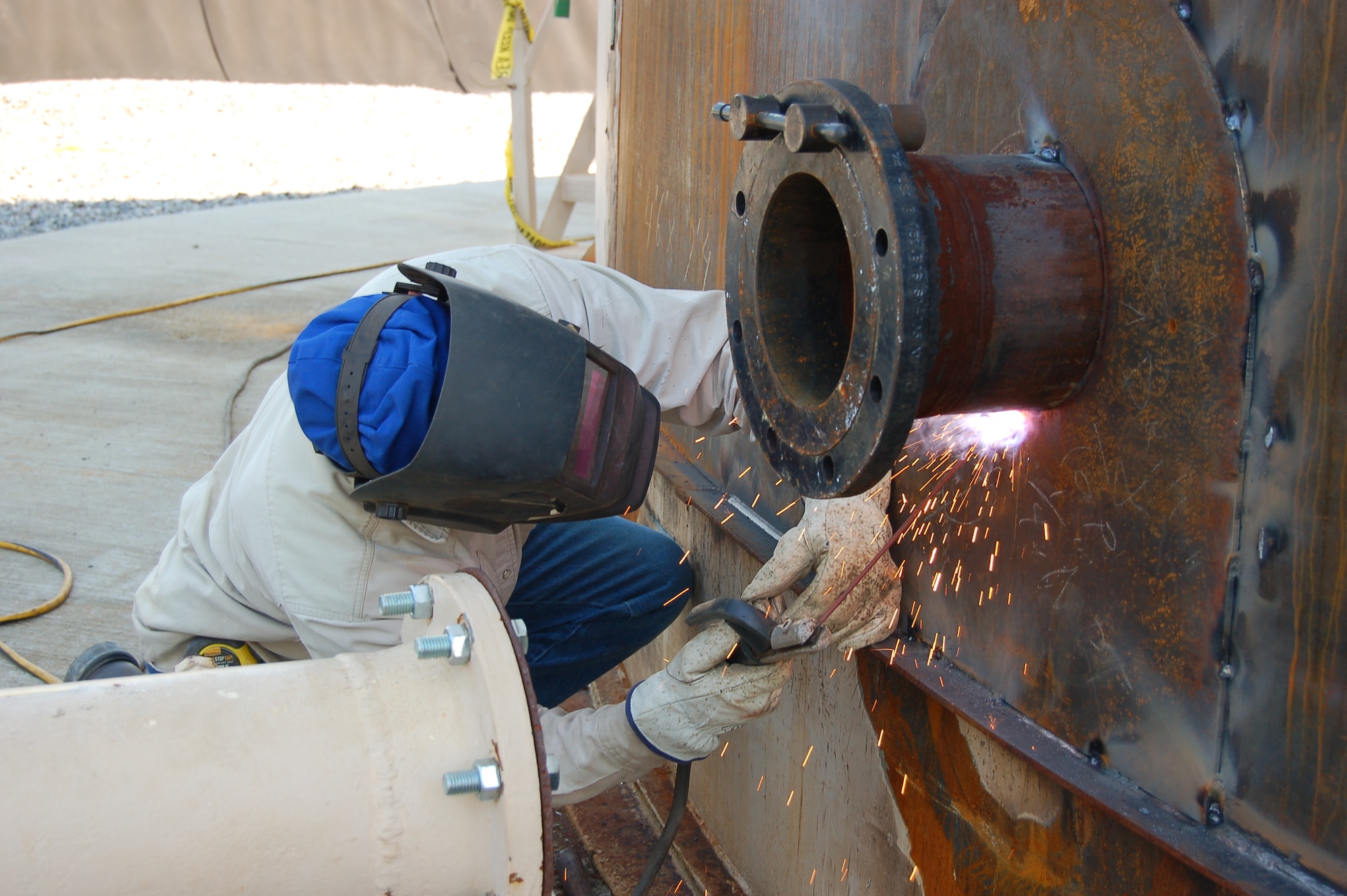 MOODY AIR FORCE BASE, Ga. -- A worker welds a supply pipe to a fuel storage tank during renovations to the bulk fuel storage facility here March 12. The upgrades are being made to improve the safety and efficiency of the facility. (U.S. Air Force photo by Tech. Sgt. Parker Gyokeres)
