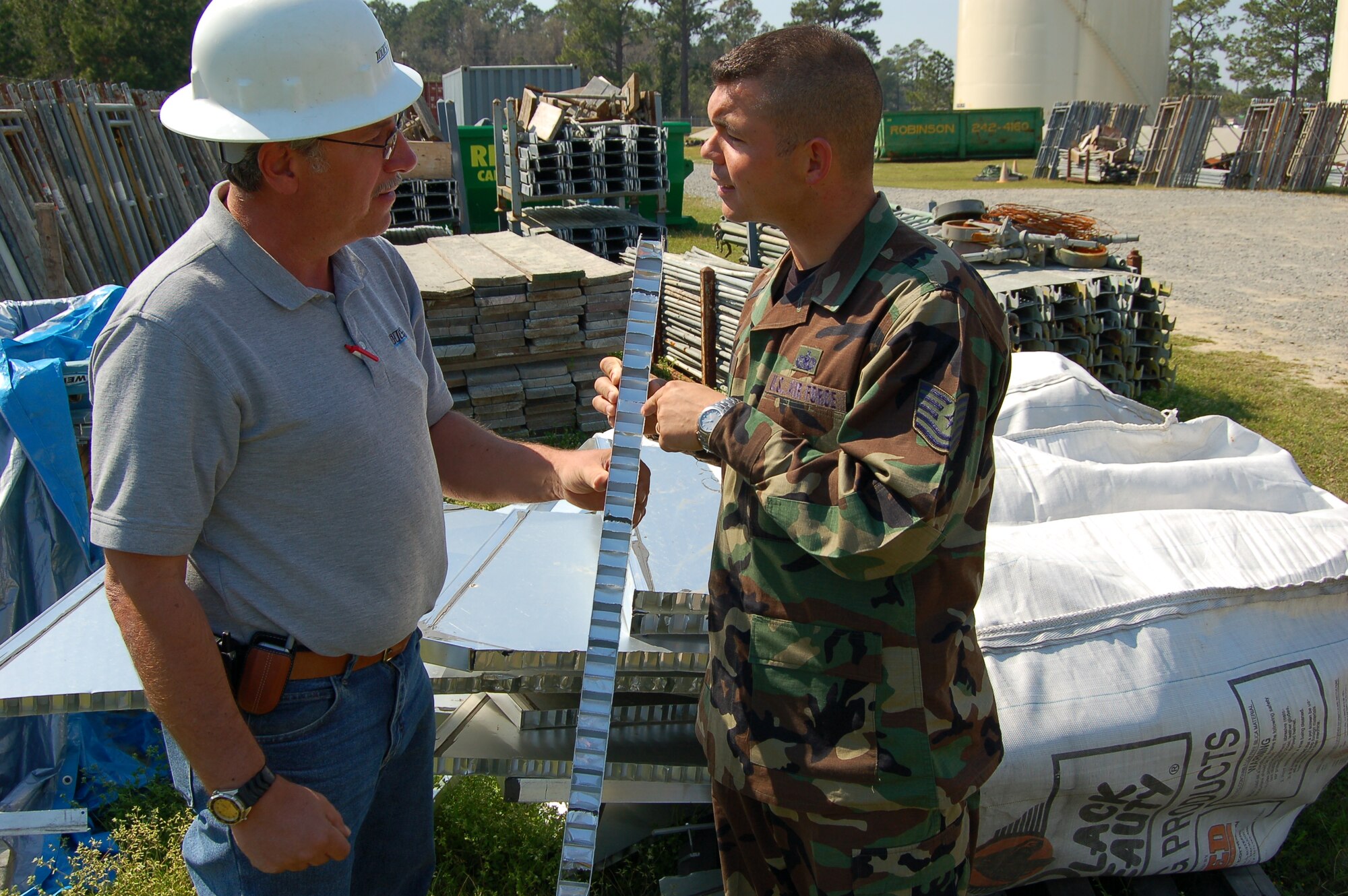MOODY AIR FORCE BASE, Ga. -- Edd Hartman, site supervisor for TolTest Inc. shows Tech Sgt. Ron Killen, 23rd Logistic Readiness Squadron fuels storage element assistant NCO-in-charge, a cross section of the floating roof that seals fuel in 5,000 and 10,000-barrel tanks. (U.S. Air Force photo by Tech. Sgt. Parker Gyokeres)