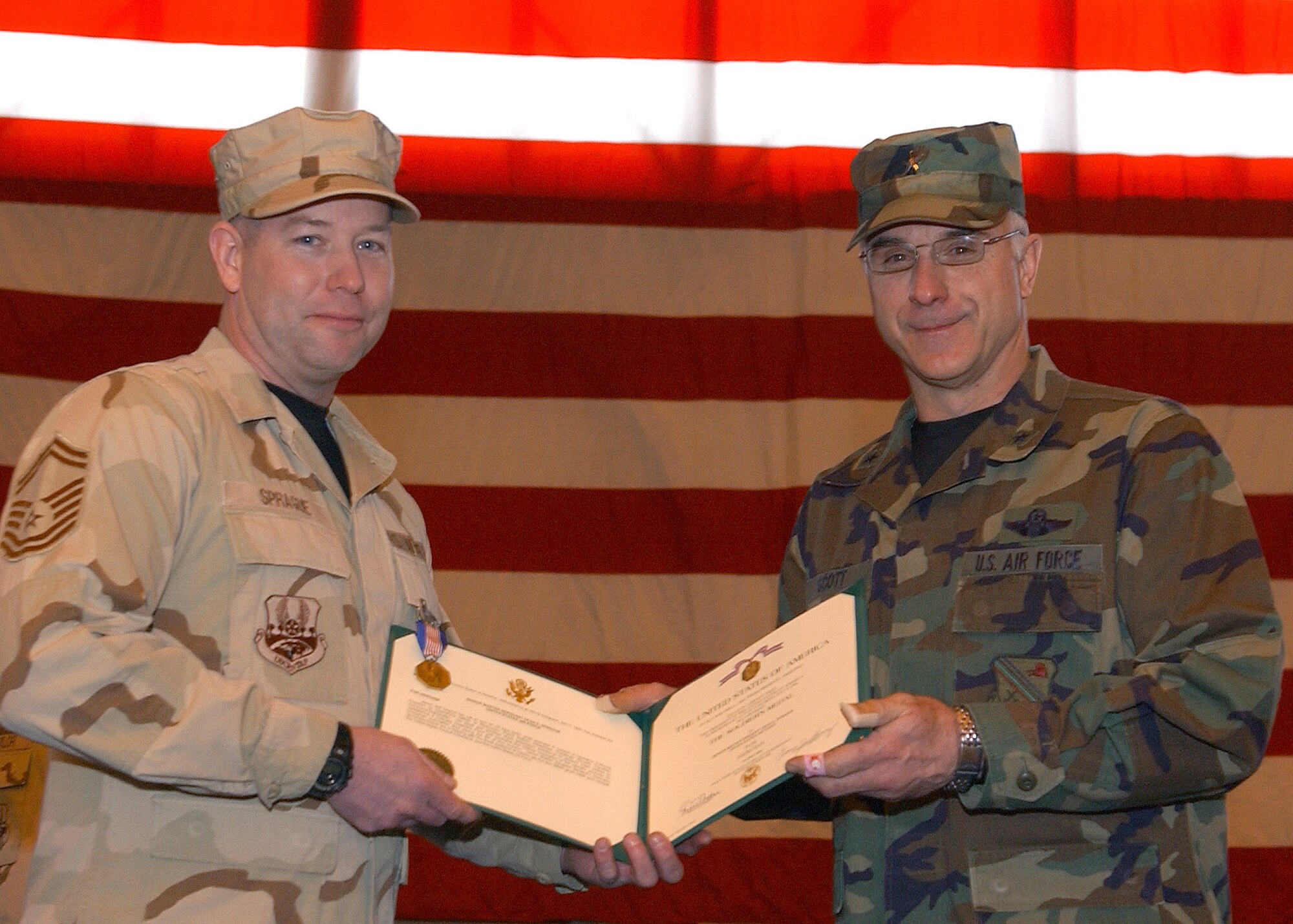 Senior Master Sgt. Dean Sprague, 354th Logistics Readiness Squadron, poses with 354th Fighter Wing Commander Brig. Gen. Dave Scott during a Welcome Home Ceremony for returning deployed airmen at Eielson Air Force Base, Alaska March 9.  Sergeant Sprague recieved the Soldier's Medal for his heroic efforts, which saved the lives of five Afghan civilians during his deployment.  (U.S. Air Force Photo/Staff Sgt. Tia Schroeder).                               