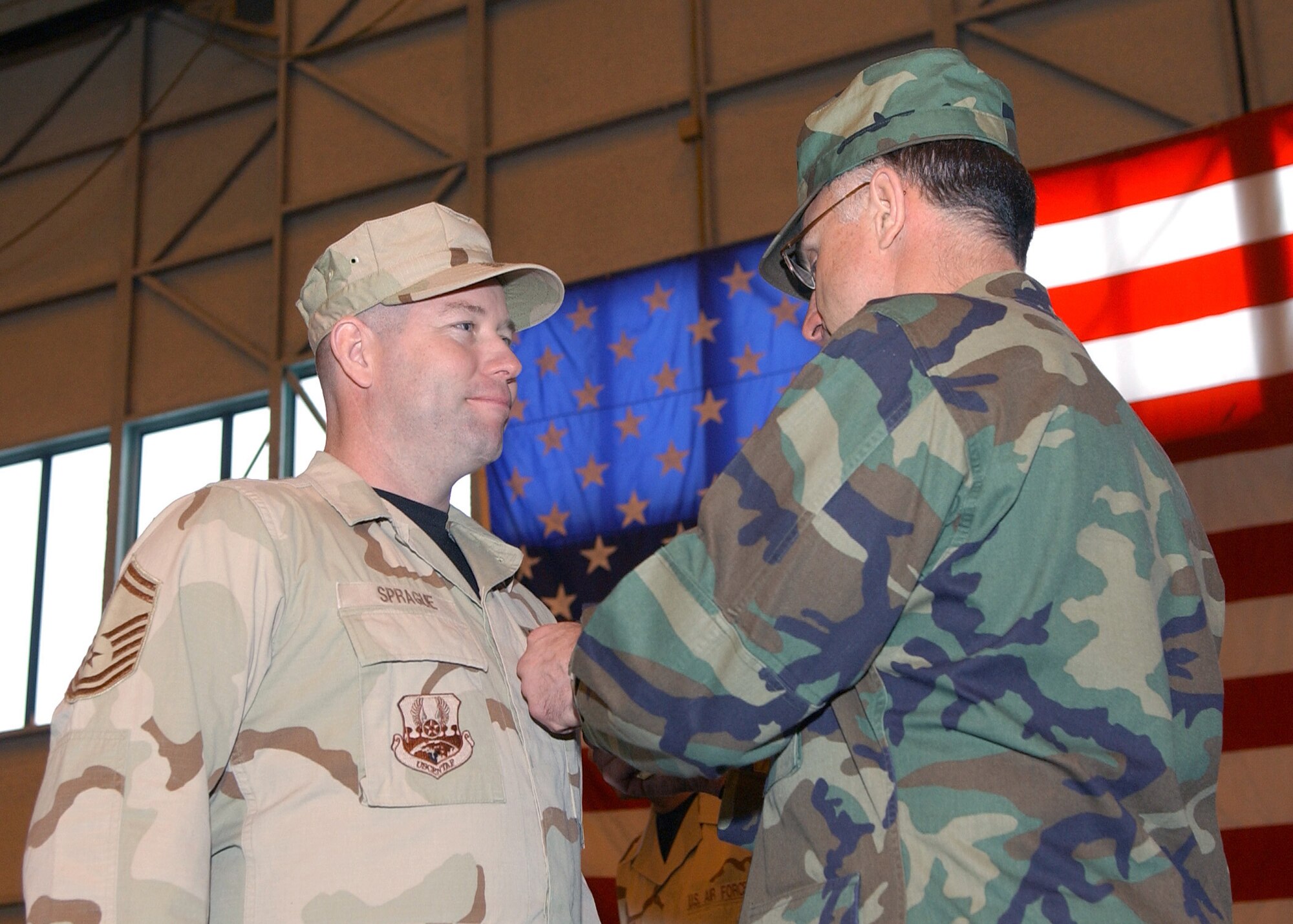 Senior Master Sgt. Dean Sprague, 354th Logistics Readiness Squadron, accepts the Soldier's Medal from 354th Fighter Wing Commander Brig. Gen. Dave Scott during a Welcome Home Ceremony for returning deployed airmen at Eielson Air Force Base, Alaska March 9.  Sergeant Sprague's heroic efforts saved the lives of five Afghan civilians during his deployment.  (U.S. Air Force Photo/Staff Sgt. Tia Schroeder).