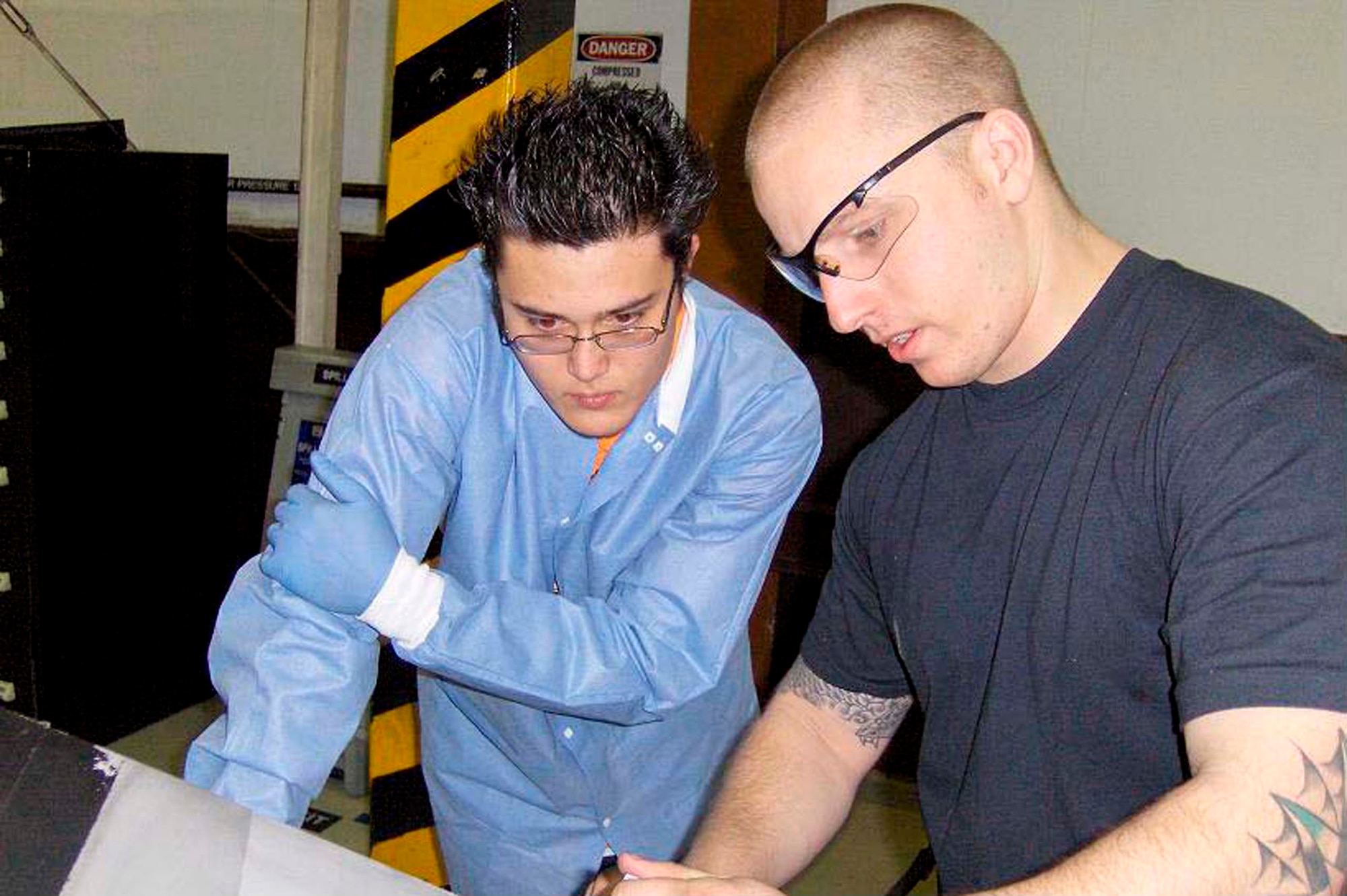 Staff Sgt. Adam Whitehurst, explains to a high school intern, how a C-130 Hercules propeller works. Sergeant Whitehurst is the assistant NCO in charge of the 86th Maintenance Squadron's propeller repair shop at Ramstein Air Base, Germany. (U.S. Air Force photo/Staff Sgt. Jason David) 