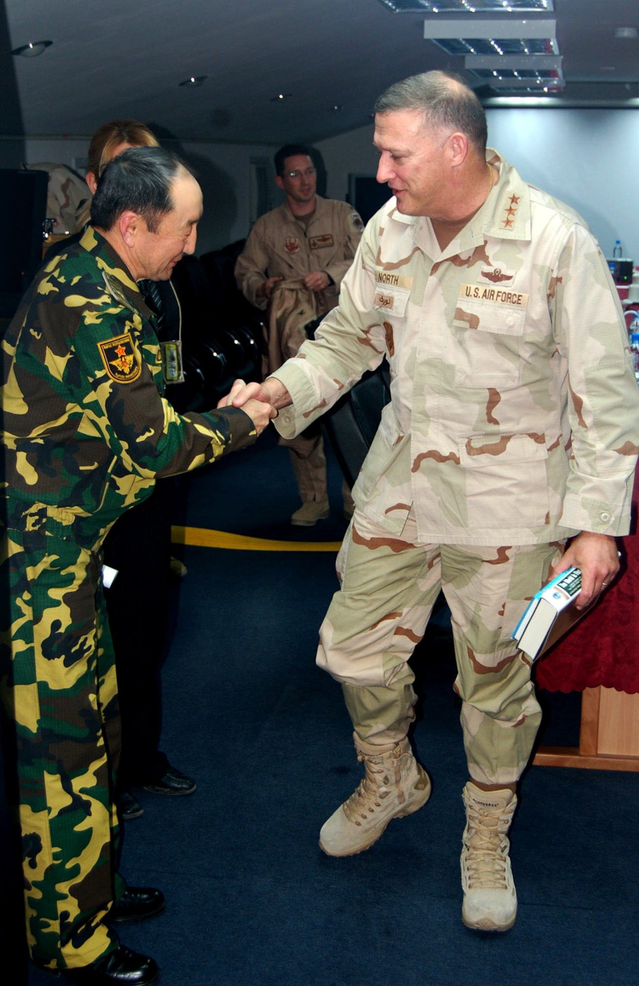 Lt. Gen. Gary North, U.S. Central Command Air Forces Commander, concludes a meeting with Gen. Kubanydjbek Oruzbaev, First Deputy Minister of Defense of Kyrgyzstan, on March 7 in the Wing Headquarters Conference Room at Manas Air Base. At the meeting, General North and General Oruzbaev discussed matters of mutual interest to both countries. (U.S. Air Force photo/Capt. Tim Wade)