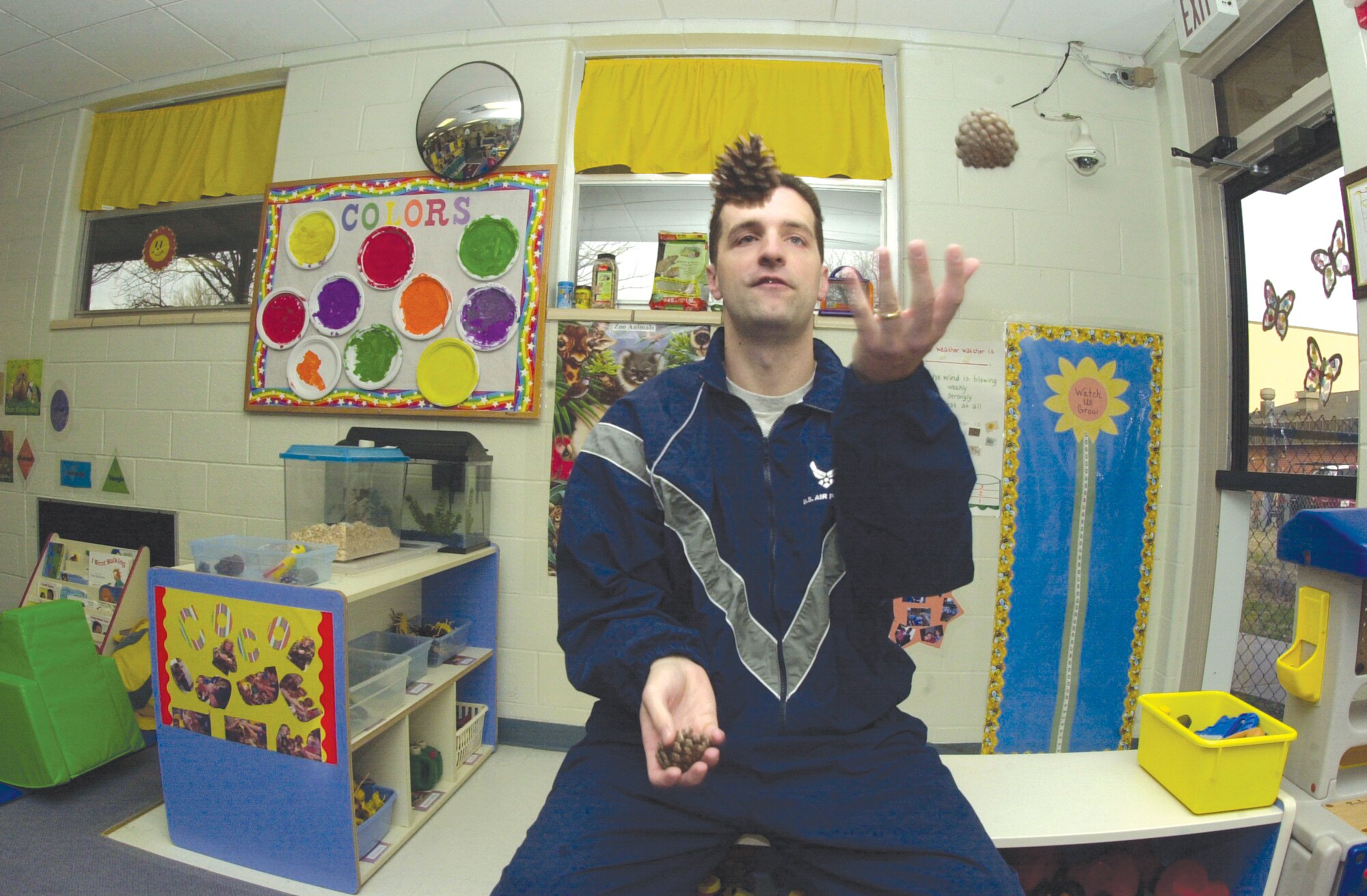 Capt. Jason Belcher, juggles three pine cones while patiently waiting for the green breakfast to arrive.