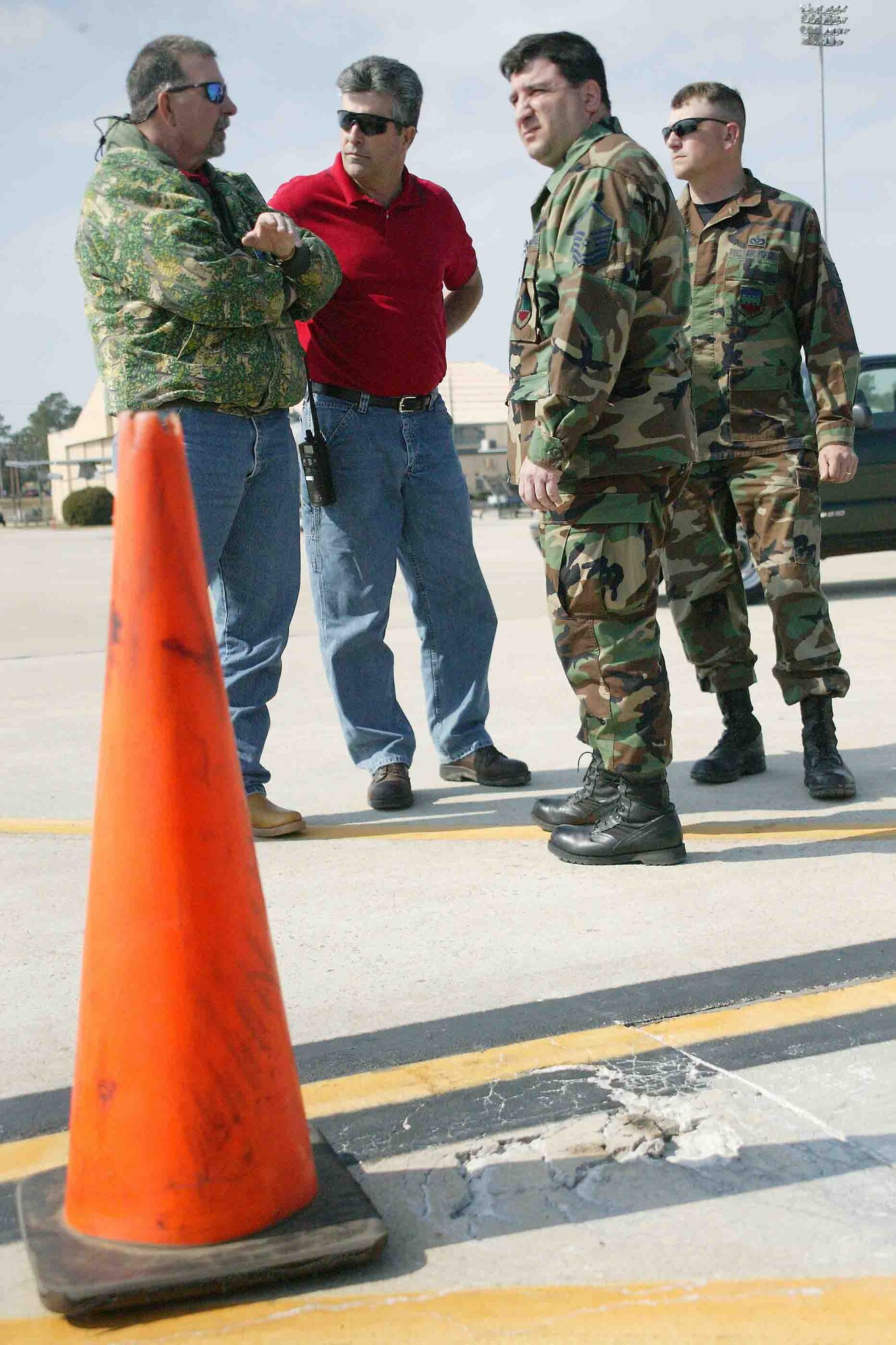 SHAW AIR FORCE BASE, S.C. -- Master Sgt. Barry Kennett, 20th Operations Support Squadron airfield manager, assesses and discusses the flightline damage March 9 with members of the 20th Civil Engineer Squadron airfield pavements engineering section. Coordinating with the 20th CES for flightline corrections and repair is one of many airfield management duties. (U.S. Air Force photo/Senior Airman John Gordinier)