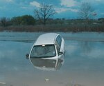 Rising water from the previous night's rain caused problems for one driver on Lackland Air Force Base, Texas, on March 12. According to the Texas Governor's Division of Emergency Management, 6 inches of water will reach the bottom of most passenger cars, causing loss of control and possible stalling. Additionally, water displaces 1,500 pounds of weight for every foot that it rises. It can take less than 2 feet of rushing water to carry off most passenger vehicles, including pick-up trucks and sports utility vehicles.

Drivers should avoid attempting to drive through flooded roadways. Water covering roads may be hiding washed-out bridges or gouged-out roadbeds. If a driver comes upon a covered road, back up instead of trying to turn around.  (USAF photo by Alan Boedeker)
                               