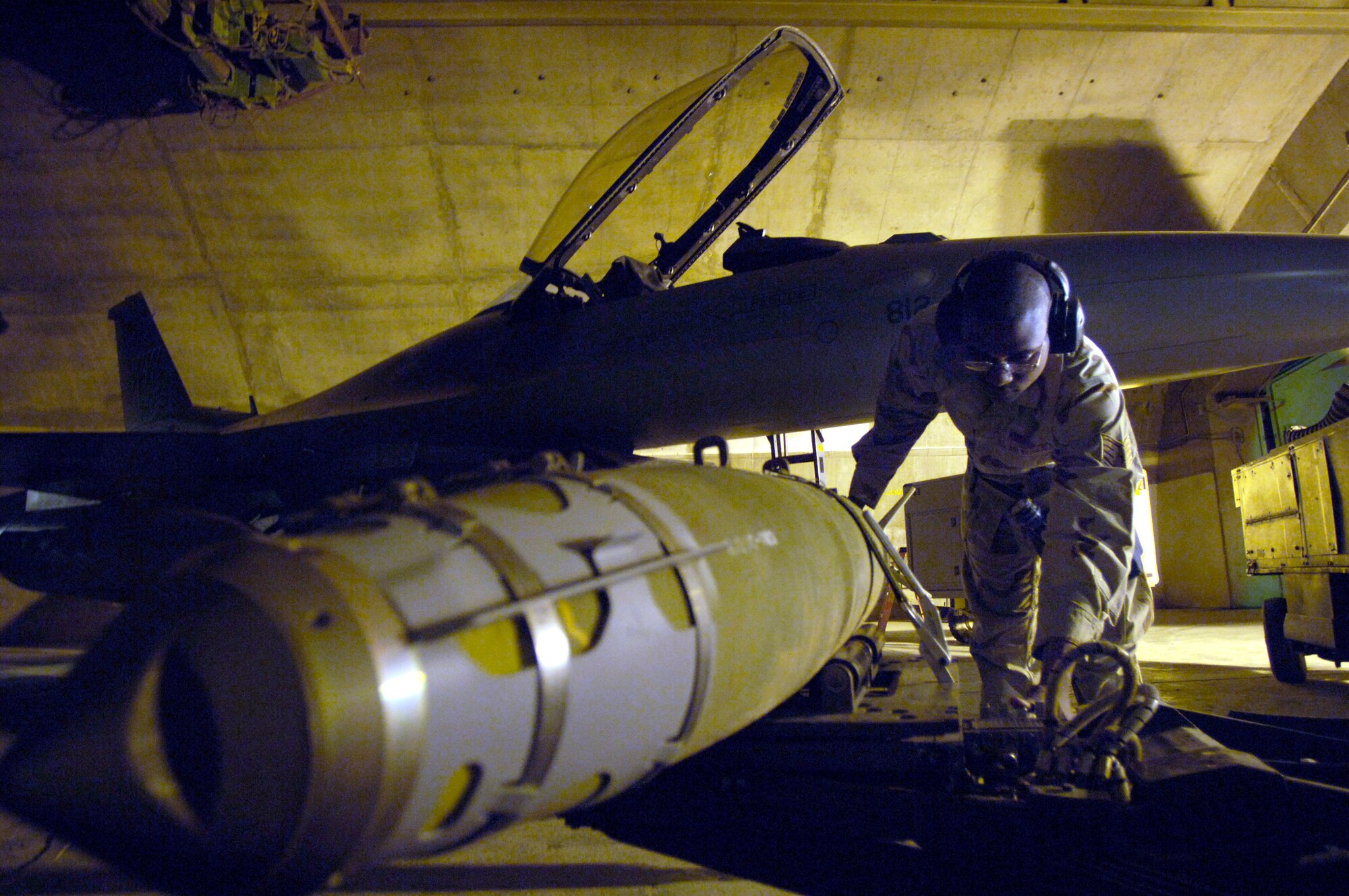 Staff Sgt. Christopher Curry prepares to load munitions on an F-16 Fighting Falcon March 4 at Balad Air Base, Iraq. He is assigned to the 332nd Expeditionary Aircraft Maintenance Squadron. (U.S. Air Force photo/Airman 1st Class Nathan Doza) 
