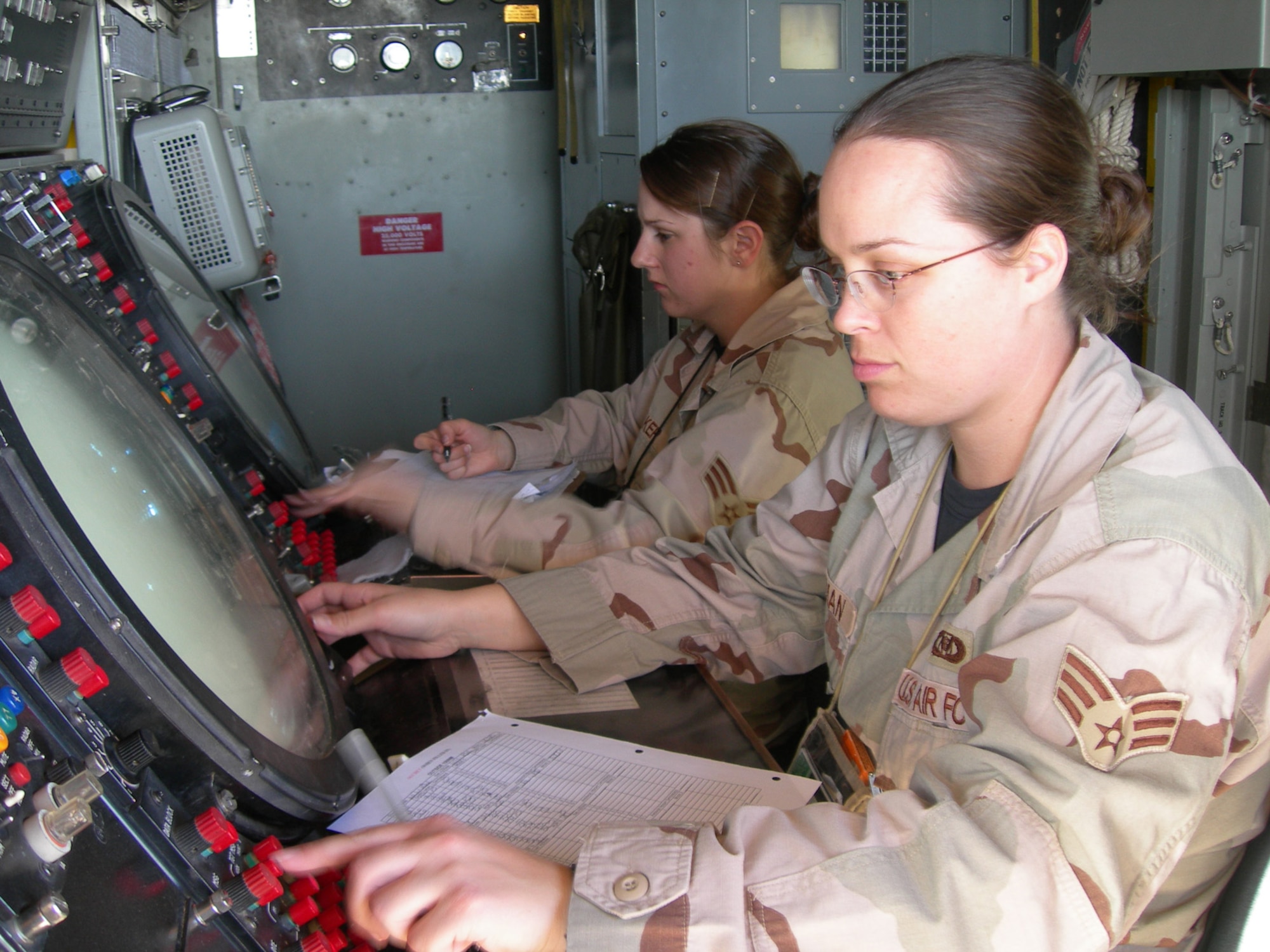 Balad Air Base, Iraq - Senior Airmen Amanda Hoffman and Rebekka Baker conduct an operational check of a AN/TPS-75 radar system at Balad Air Base, Iraq. Both Airmen are assigned to the 727th Expeditionary Air Control Squadron (EACS) and are deployed from the 728th Air Control Squadron at Eglin Air Force Base, Fla. Also known as Kingpin, the 727th EACS is responsible for maintaining positive control over aircraft operating in Iraq's 277,000 miles of airspace. (U.S. Air Force photo/Major Damien Pickart)           