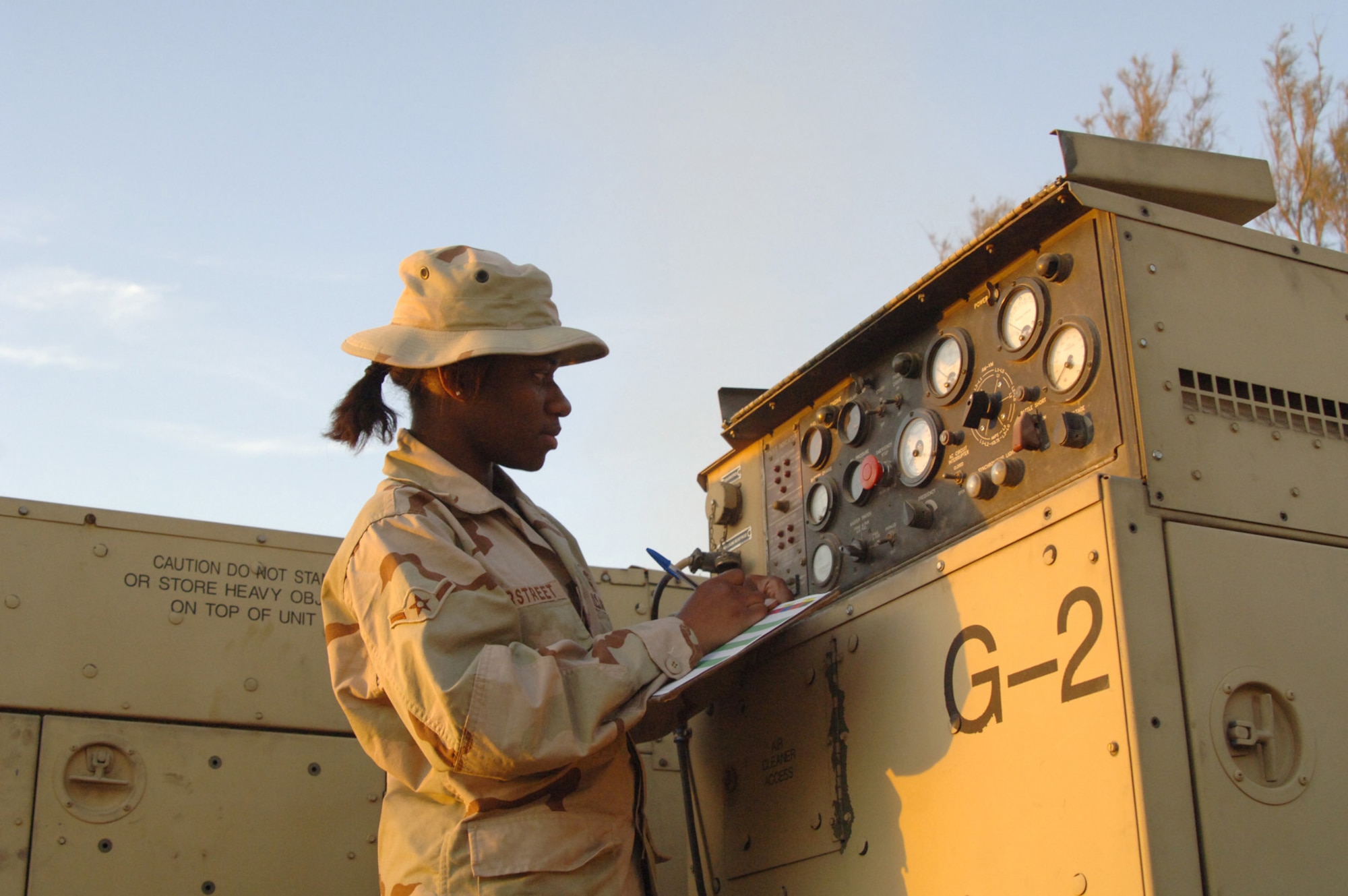 Balad Air Base, Iraq - Airman Yana Overstreet, an Air Ground Equipment (AGE) maintainer, conducts a routine systems check of a generator at Balad Air Base, Iraq. Airman Overstreet is assigned to the 727th Expeditionary Air Control Squadron (EACS) and is deployed from the 728th Air Control Squadron at Eglin Air Force Base, Fla. Also known as Kingpin, the self-sustaining 727th EACS is comprised of nealry 200 Airmen from 27 different Air Force specialties. AGE maintainers are critical to supplying unique power requirements to Kingpin's radar control equipment, ensuring positive control over aircraft operating in Iraq's 277,000 miles of airspace. (U.S. Air Force photo/Major Damien Pickart)               