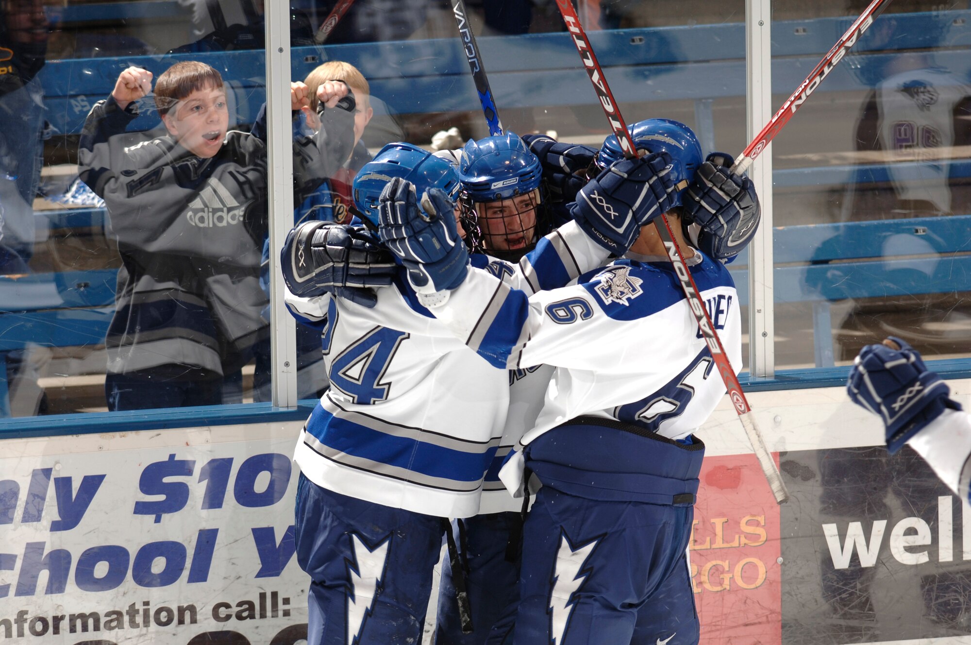 Mike Phillipich (center) is mobbed by his teammates after his goal early in the third period gave Air Force a 2-0 lead over Holy Cross. The Falcons went on to win 3-0 in the quarterfinals of the Atlantic Hockey Association Tournament. (Courtesy photo/Mike Kaplan)