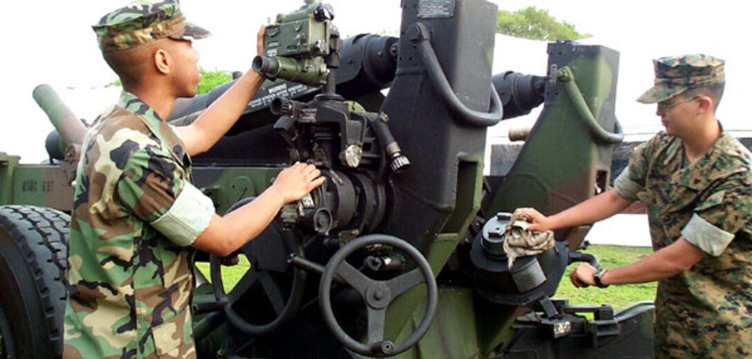 U.S. Marine reservist Lance Cpls. Wilbert Allen, left, and Christopher Morehouse tend to their M-198 howitzer early May 2, the opening day of this year's Public Service Recognition Week exhibits on the National Mall in Washington, D.C. Photo by Gerry J. Gilmore