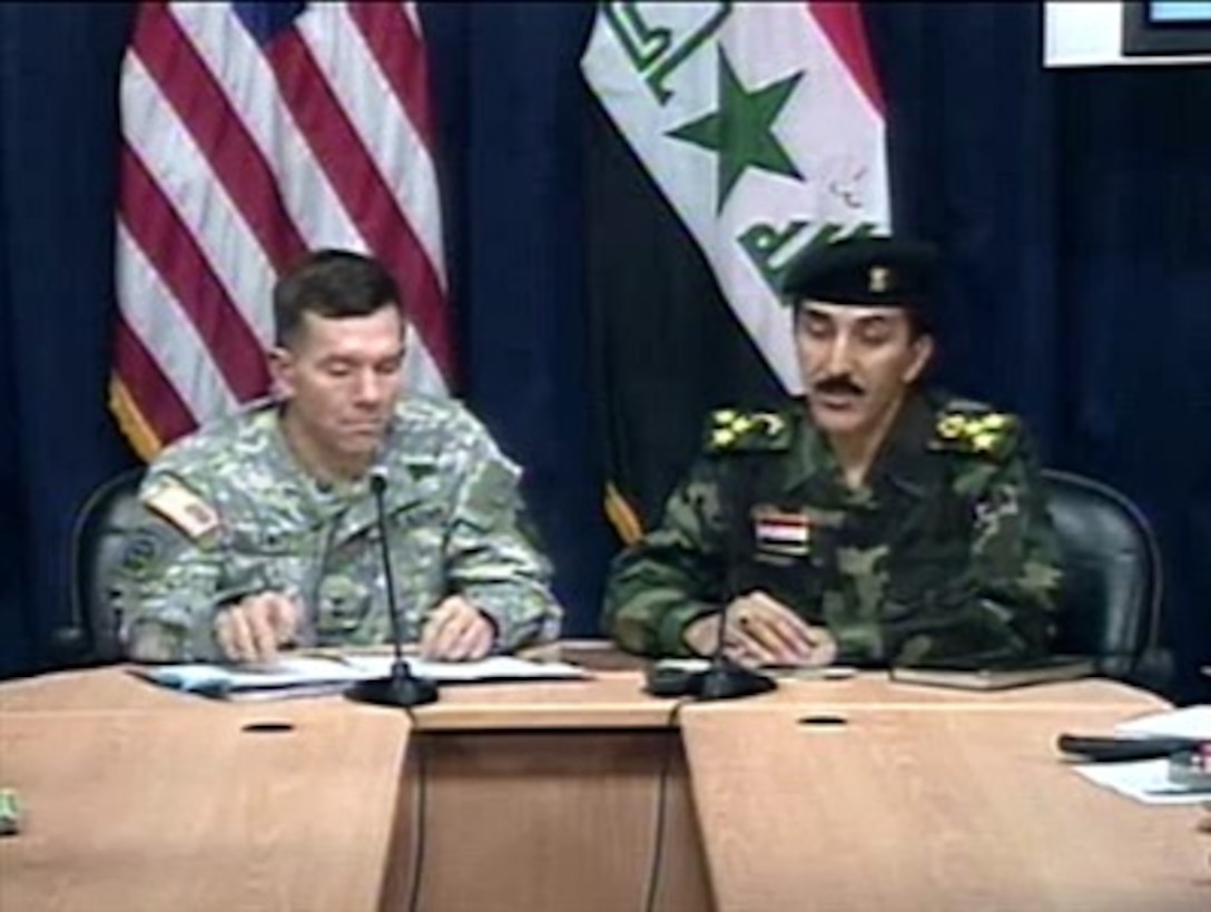 Multi-National Force-Iraq spokesman U.S. Army Maj. Gen. William Caldwell and Iraqi Brig. Gen. Qassim Atta speak with reporters in Baghdad, March 12. 2007.
