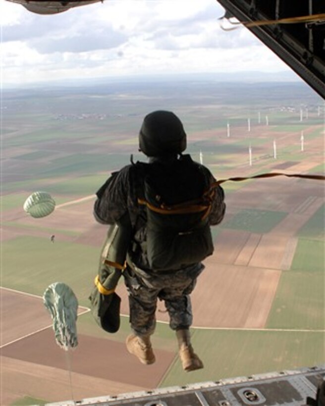 A U.S. Air Force airman steps off the aircraft ramp as he joins other airmen and U.S. Army soldiers as they execute an airborne jump exercise over Southwestern Germany on March 7, 2007.  The airmen are attached to the 786th Security Forces Squadron, Sembach Air Base, Germany.  The soldiers are attached to the 5th Quartermaster Detachment (Aerial Delivery).  