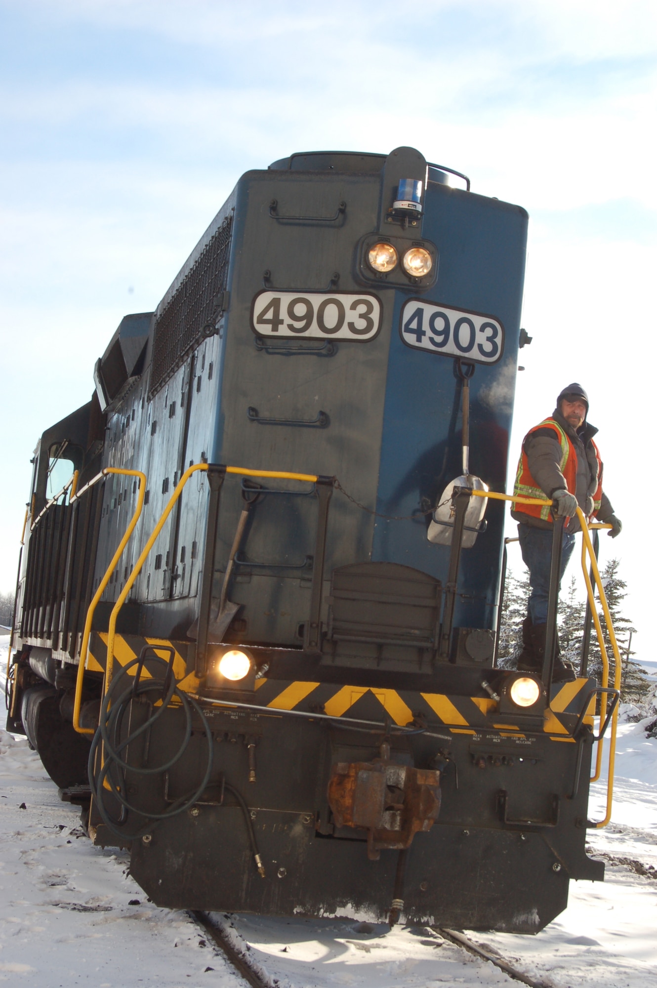 The Eielson Air Force Base coal train locomotive pulls into the base's central heat and power plant. The base has the second largest railroad in Alaska, which supplies the plant with all the coal used in heat and power production. Each freight car holds 100 tons of coal used to fill the power plant's six, 200-ton coal bunkers. The plant can burn up to 40,000 pounds of coal per hour. (U.S. Air Force photo/Staff Sgt. Matthew Rosine) 