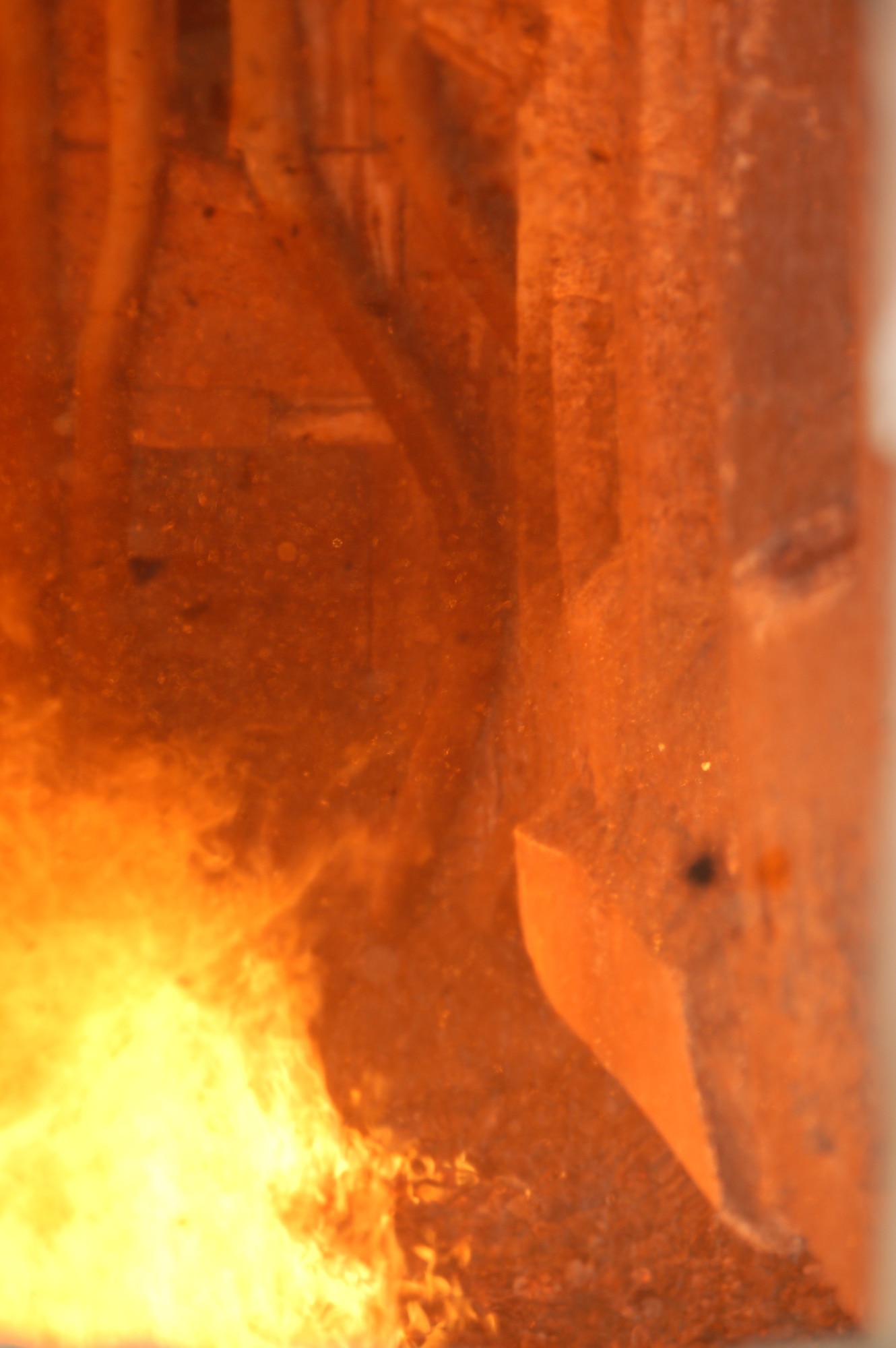 Coal falls into one of the boiler furnaces at the central heat and power plant at Eielson Air Force Base, Alaska, Feb. 28. The 700-degree furnaces at the plant can burn more than 40,000 pounds of coal per hour. These boilers produce more than 380,000 pounds of steam per hour, which is used to create heat and electricity for the base. Only 150 miles away from the Arctic Circle, temperatures at the base can drop to more than 60 degrees below zero during the winter. (U.S. Air Force photo/Staff Sgt. Matthew Rosine) 