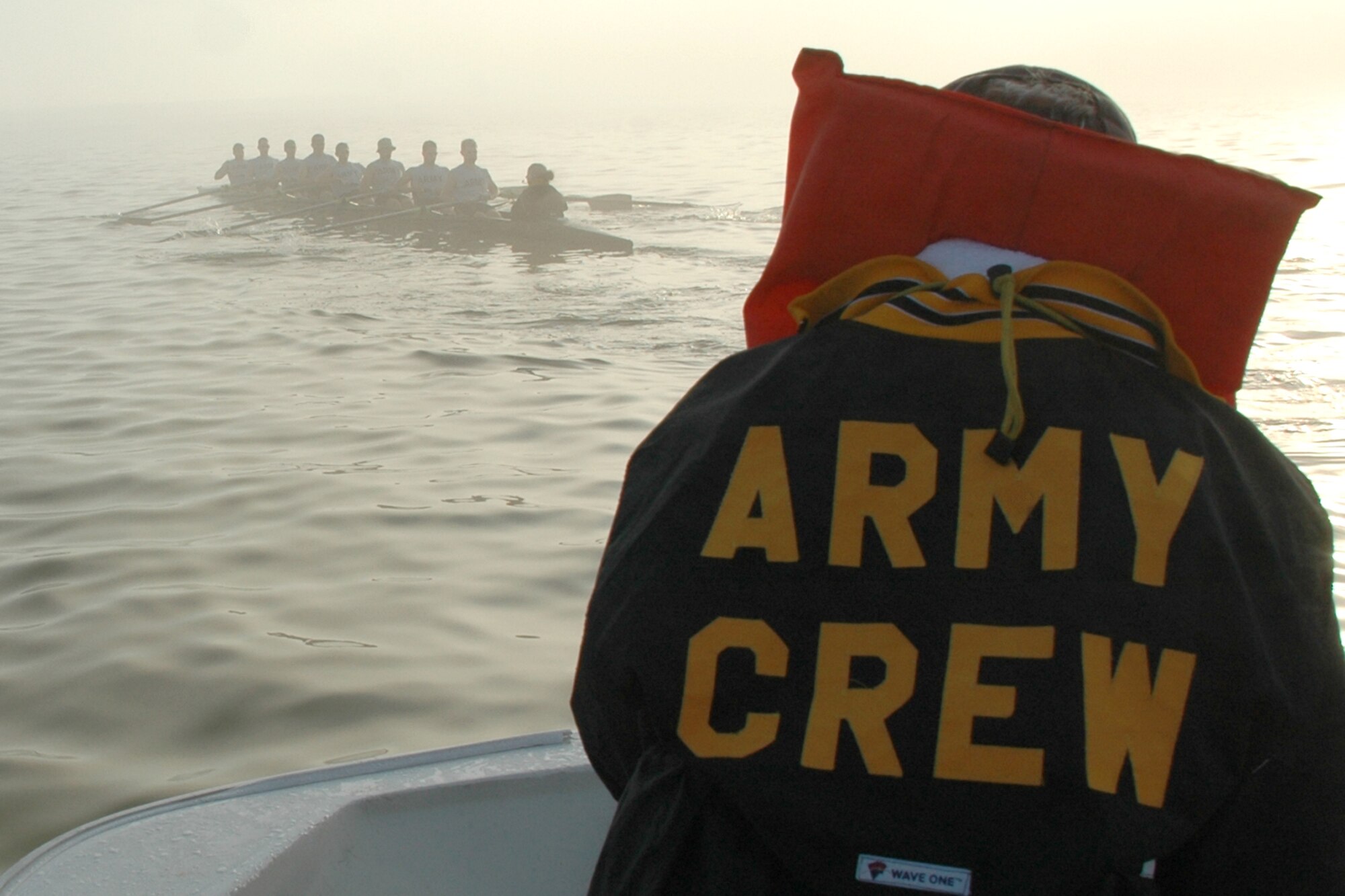 EGLIN AIR FORCE BASE, Fla. -- Jim Swisher, U.S. Military Academy Crew Team assistant coach, communicates to the men's varsity and novice squads through a thick fog on the Choctawhatchee Bay during an early morning workout March 13. The fog forced them to leave the bay and head for safer waters in the local bayous. The Army crew team is split up into four squads: men's varsity and novice, and women's varsity and novice. The team is here during their spring break to practice in the warmer Florida temperatures. (U.S. Air Force photo by Staff Sgt. Mike Meares)