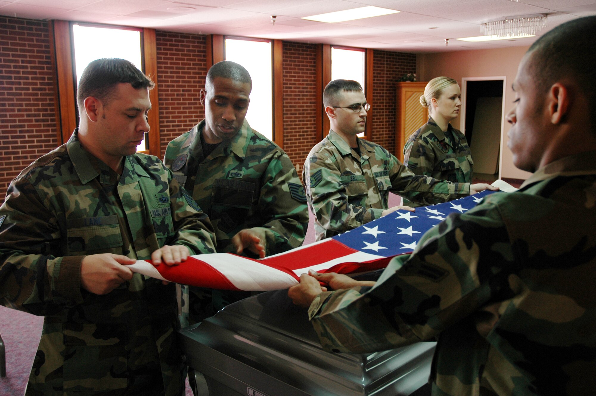 Tech. Sgt. Charles Forrest (second from left), an instructor with the Air Force Honor Guard from Bolling Air Force Base, teaches flag folding techniques to area honor guard members. The AF Honor Guard team was here for two weeks instructing Canon, F.E. Warren, Schriever, Peterson and Air Force Academy honor guard members. (U.S. Air Force photo by Steve Brady)