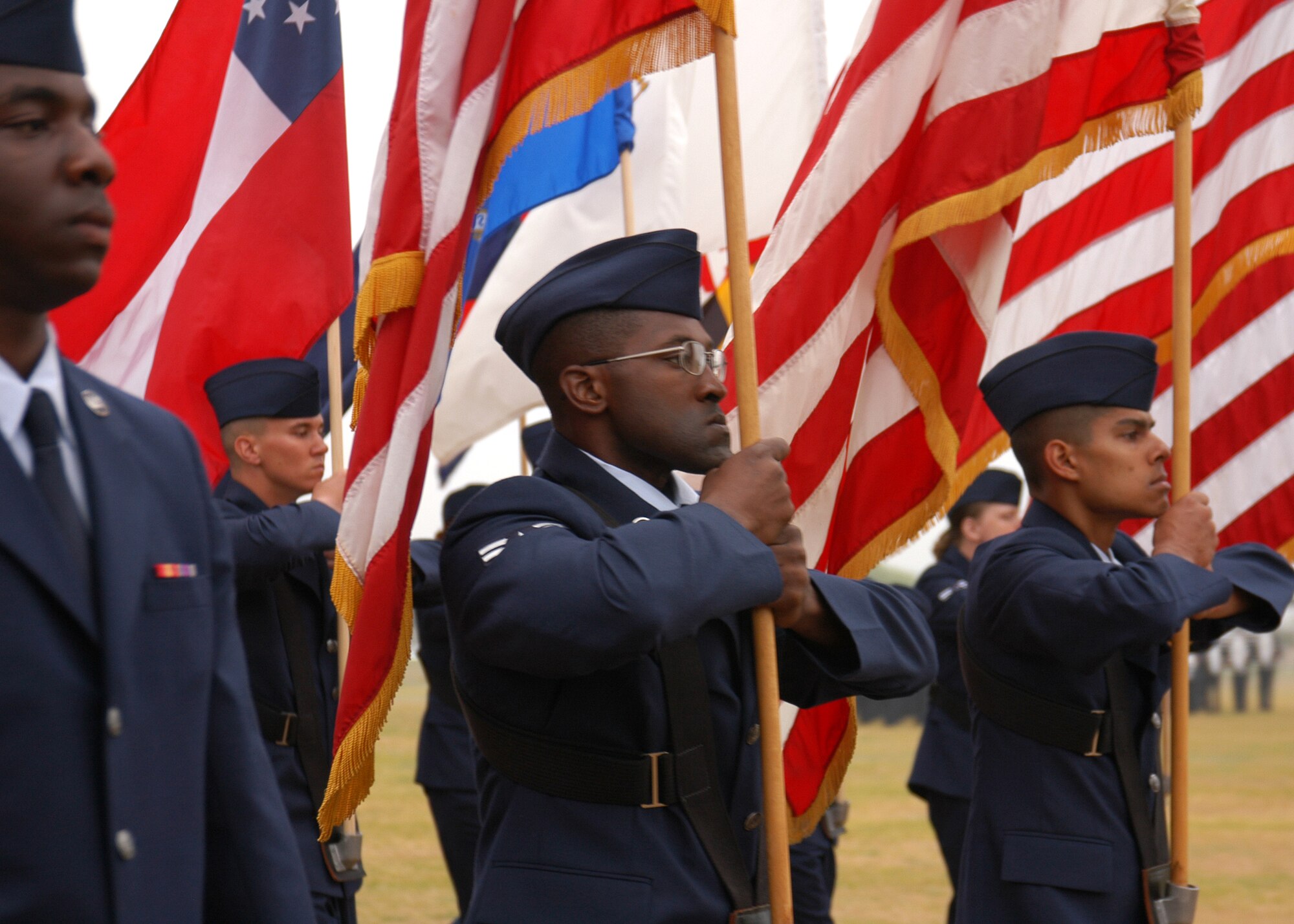 Air Force trainees carry U.S. and state flags with pride during their Basic Military Training graduation parade March 9 at Lackland Air Force Base, Texas. The Air Force met its monthly recruiting goals in January and February and continues to recruit quality men and women for more than 150 active-duty specialties in fields such as medical, aviation, engineering, mechanical, communications, security forces, special operations and more. Visit www.airforce.com for more information. (Staff Sgt. Jennifer Lindsey)         