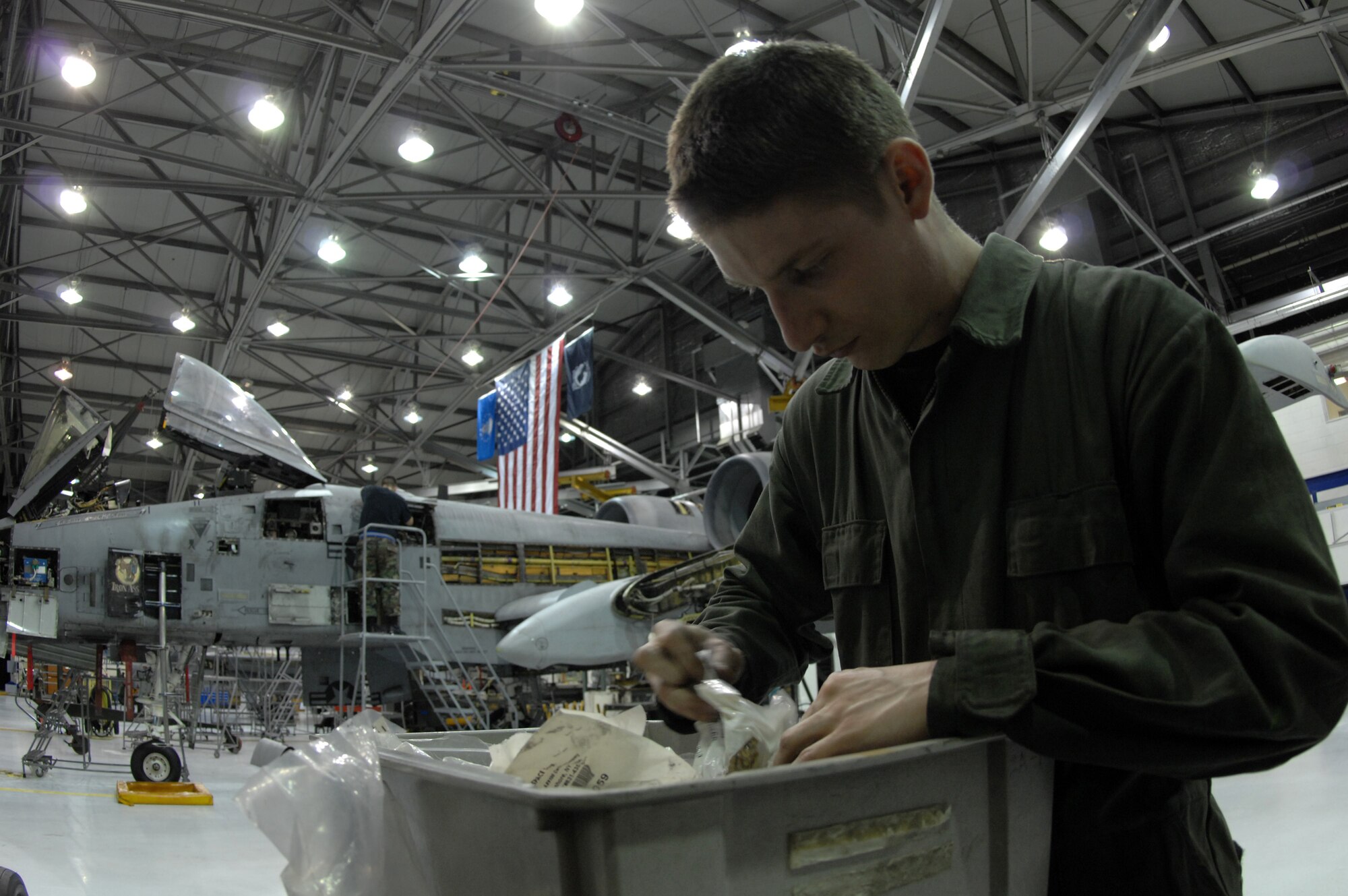 EIELSON AIR FORCE BASE, Alaska -- Airman First Class Guy Mitchell, 354th Aircraft Maintenance Squadron, searches for parts for an A-10 Thunderboly II during phase maintenance on Mar. 13 while Staff Sgt Jason Belanger,  354th Maintenance Squadron, inspects a section of the aircraft in the background. Phase maintenance is an overhaul of the entire aircraft which ensures it is ready for safe flight.The 354th Maintenance Squadron is in charge of the Phase program and can turn an A-10 around in 10 days.
(U.S. Air Force Photo by Staff Sgt Joshua Strang)