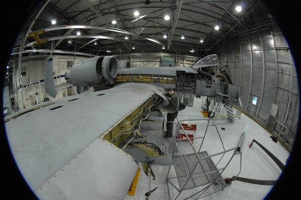 EIELSON AIR FORCE BASE, Alaska -- Airman First Class Guy Mitchell, 354th Aircraft Maintenance Squadron, removes an A-10 Thunderbolt II leading edge panel during phase maintenance on Mar. 13 while Staff Sgt Jason Belanger and Senior Airman Timothy Jeter, both of the 354th Maintenance Squadron, work on the cockpit section in the background. Phase maintenance is an overhaul of the entire aircraft which ensures it is ready for safe flight.The 354th Maintenance Squadron is in charge of the Phase program and can turn an A-10 around in 10 days. 
(U.S. Air Force Photo by Staff Sgt Joshua Strang)