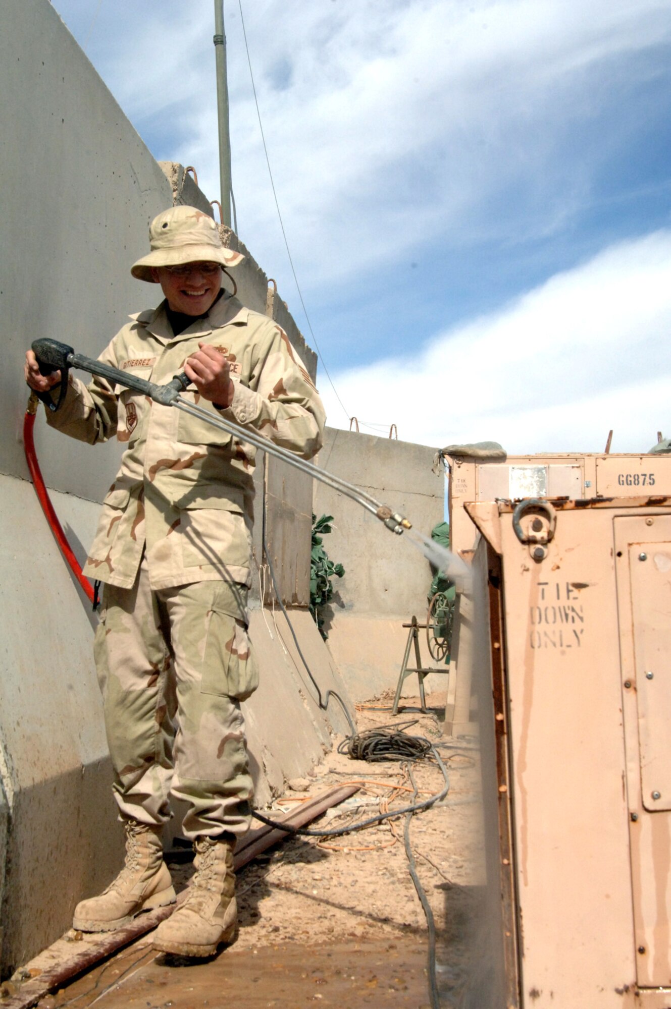 Staff Sgt. Robert Gutierrez, an air ground equipment maintainer, power washes dirt and debris from an air conditioning unit March 9 to improve its efficiency and performance at Balad Air Base, Iraq. Sergeant Gutierrez is assigned to the 727th Expeditionary Air Control Squadron and is deployed from the 33rd Maintenance Squadron at Eglin Air Force Base, Fla. (U.S. Air Force photo/Maj. Damien Pickart) 
