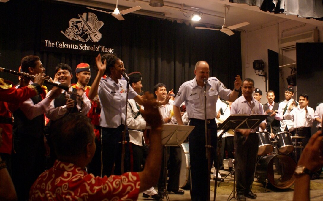 CALCUTTA, India -- Staff Sgts Darren Keenom and Felita Rowe lead the attendees of the Band of the Pacific-Asia's Music clinic at the Calcutta School of Music in a famous Indian Pop tune. The Pacific Air Forces rock group, Pacific Trends, was invited by the Chief of Staff of the Indian Air Force to help celebrate the Indian Air Force’s 75th Anniversary. 