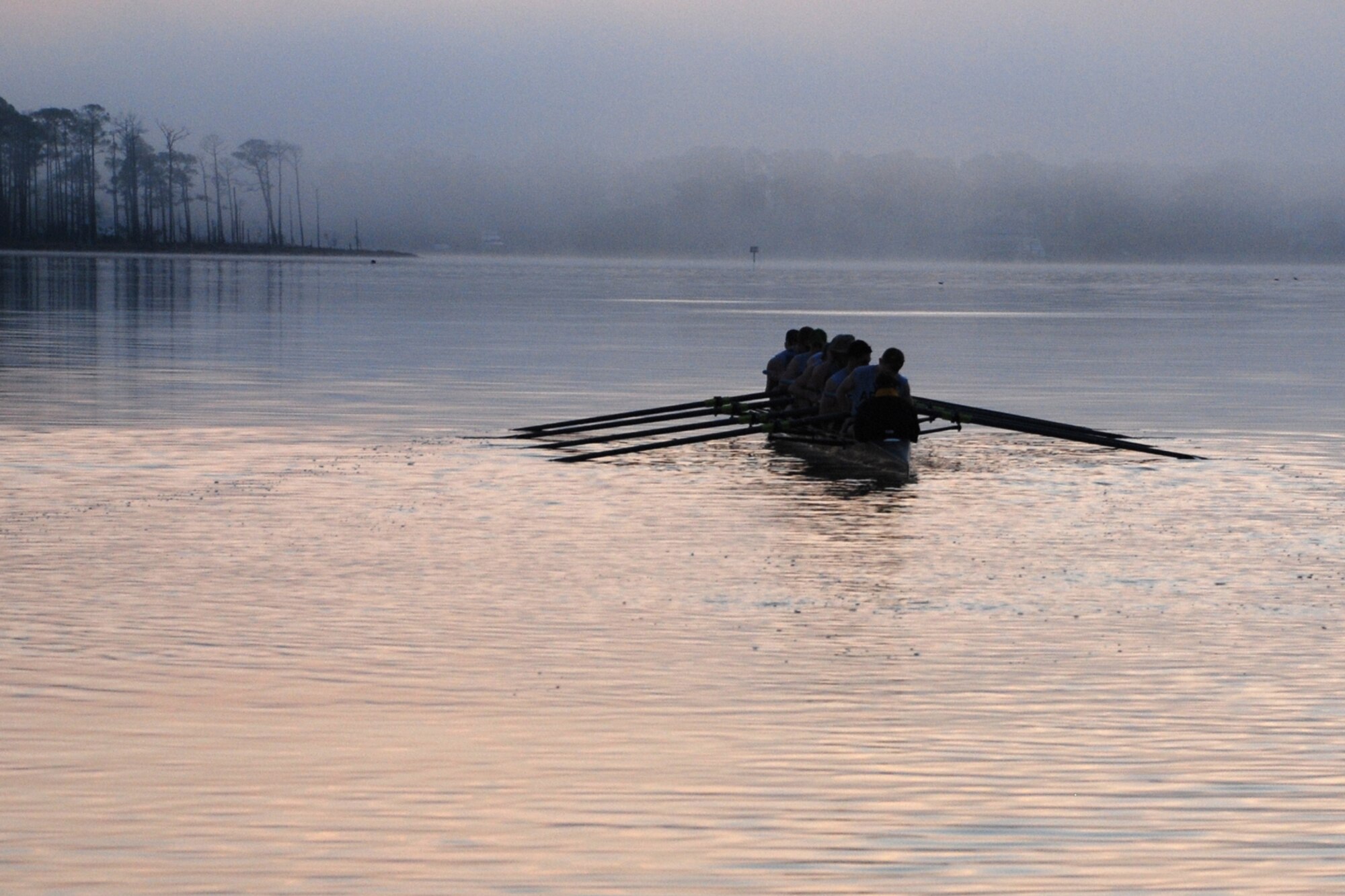 EGLIN AIR FORCE BASE, Fla. -- The fog rolls in over the water as the U.S. Military Academy Crew Team, West Point, N.Y., sets out from Postal Point during an early morning workout March 13 in Choctawhatchee Bay. The team is split up into four squads: men's varsity and novice, and women's varsity and novice. The team is here during their spring break to practice in the warmer Florida temperatures. (U.S. Air Force photo by Staff Sgt. Mike Meares)