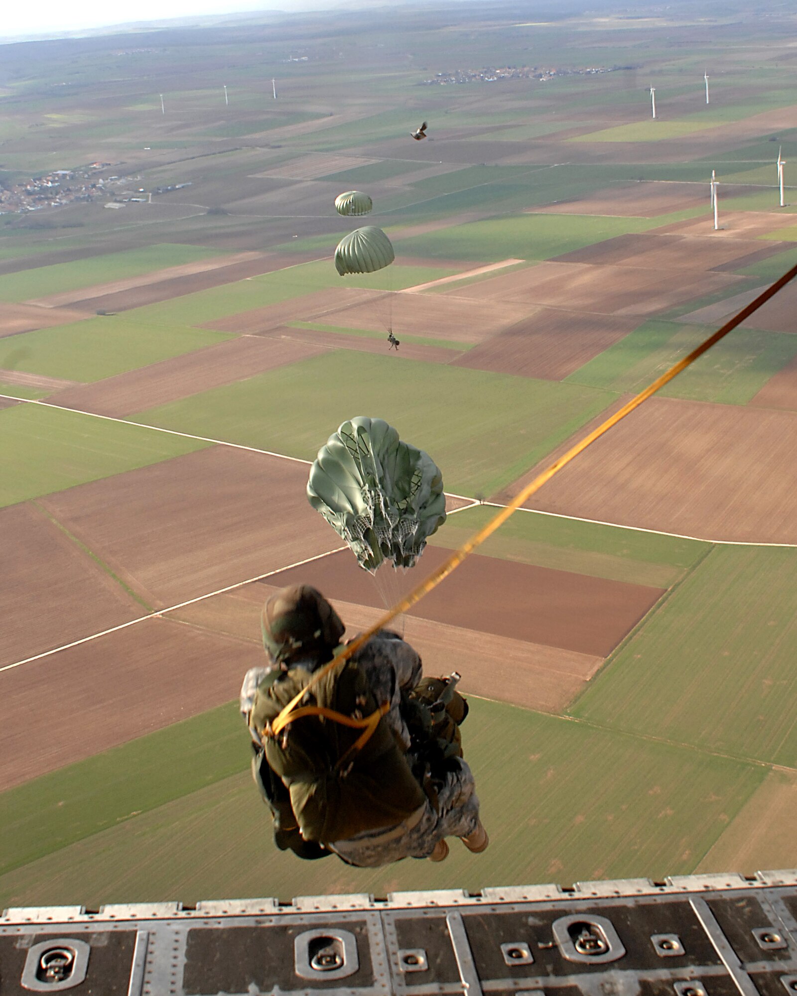 Airmen of the 786th Security Forces Ravens from Sembach Annex, Germany and Soldiers from the 5th Quarter Master Arial Delivery crew execute an airborne jump exercise March 7 over southwestern Germany. (U.S. Air Force photo/Airman Kenny Holston) 