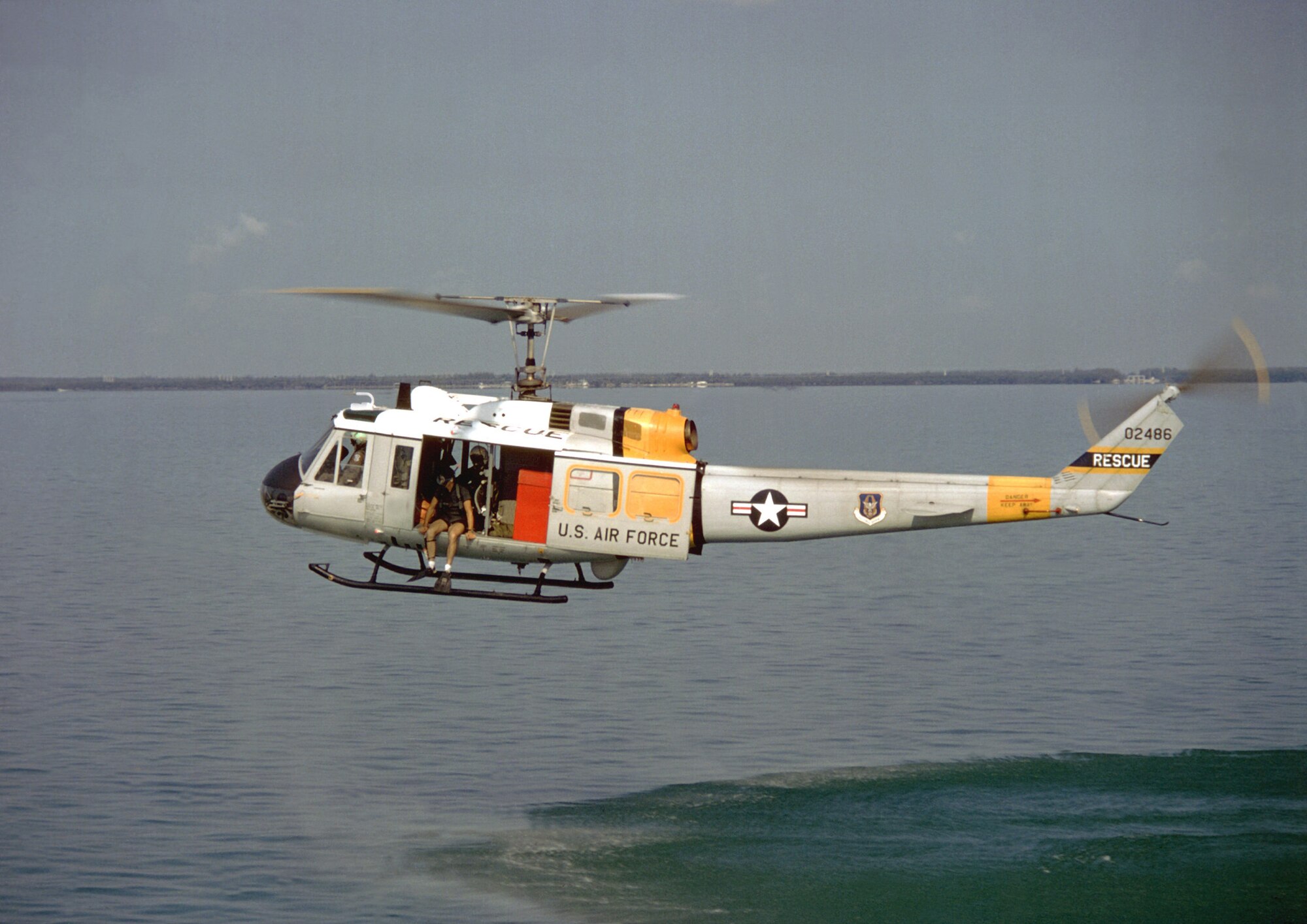 The crew of an Air Force Reserve HH-1H Iroquois conducts search and rescue training. The HH-1H was the first turbine engine Air Force Reserve helicopter. (Photo/National Archives 1983)