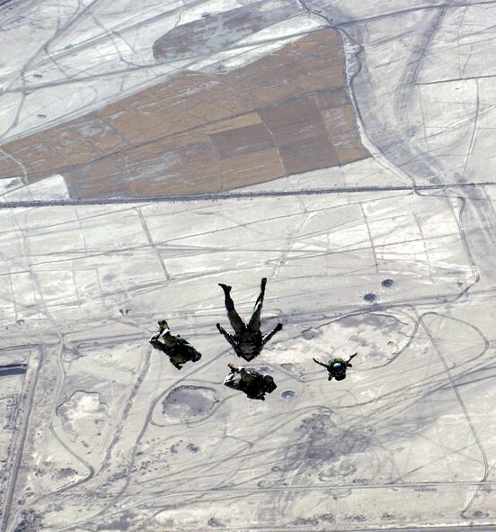 US Air Force Reserve Pararescuemen assigned to the 301st Rescue Squadron, perform a high altitude low opening parachute jump over Tallil Air Base, Iraq, during Operation Iraqi Freedom. (U.S. Air Force photo/Staff Sgt. Shane Cuomo)