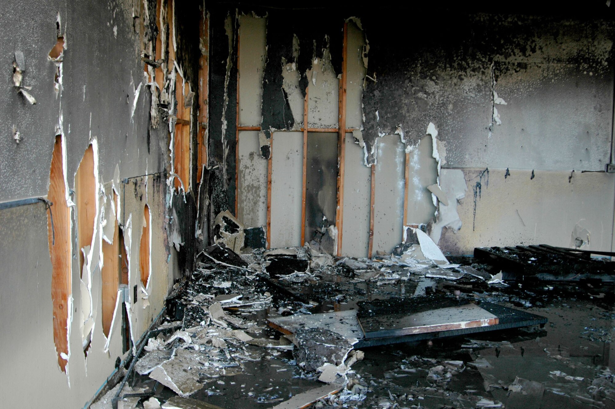 MOUNTAIN HOME AIR FORCE BASE, Idaho -- Scorched walls in Bldg. 1612 here bear the aftermath of a live fire training exercise March 12. Firefighters from the 366th Civil Engineer Squadron conducted the exercise to ensure the base complies with environmental standards before the building is used for larger fire-training drills. The building, previously scheduled for demolition, is helping fire fighters here hone their skills. Air Force photo by Airman Samantha S. DeVries