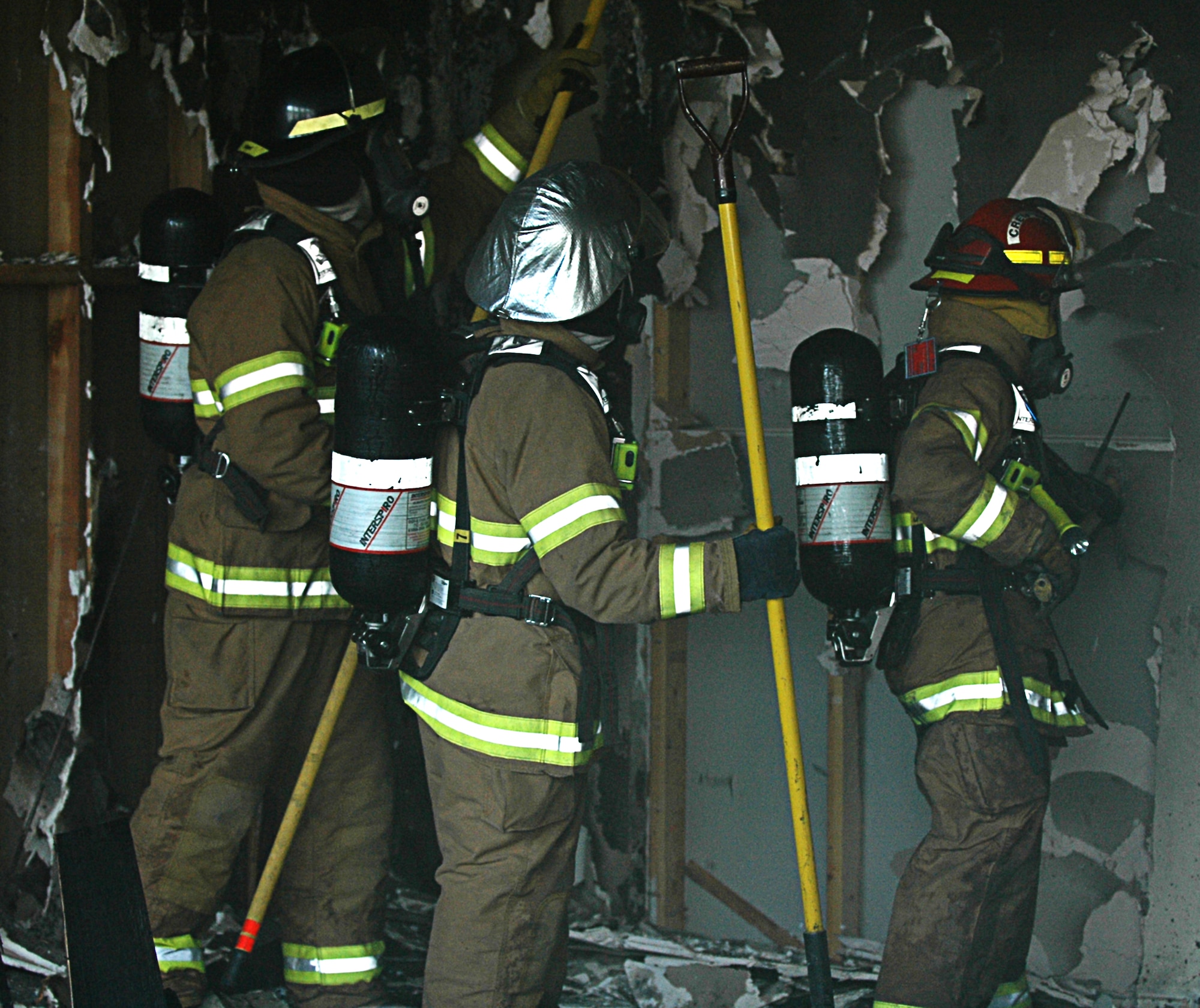MOUNTAIN HOME AIR FORCE BASE, Idaho -- Firefighters from the 366th Civil Engineer Squadron here collect samples after a live fire exercise March 12 in Bldg. 1612. The samples will be tested to ensure the base complies with environmental standards before the building is burned on a larger scale for additional fire training drills. The building, previously scheduled for demolition, is helping fire fighters here hone their skills. Air Force photo by Airman 1st Class Ryan Crane