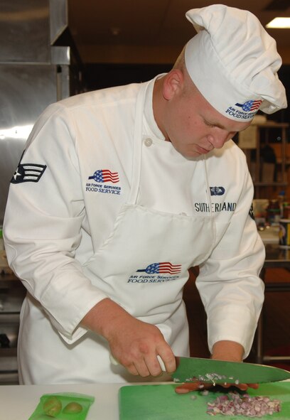 MINOT AIR FORCE BASE, N.D. – Senior Airman David Sutherland, 91st Operations Support Squadron chef, slices an onion during a chef competition. Chefs from the 91st Space Wing deploy in four-day increments to each of the wing’s 15 missile alert facilities to cook four meals a day for no fewer than 10 people, including security forces tactical fire teams, two-officer missile combat crews and the on-site facility manager. (U.S. Air Force photo by Airman Joe Rivera)