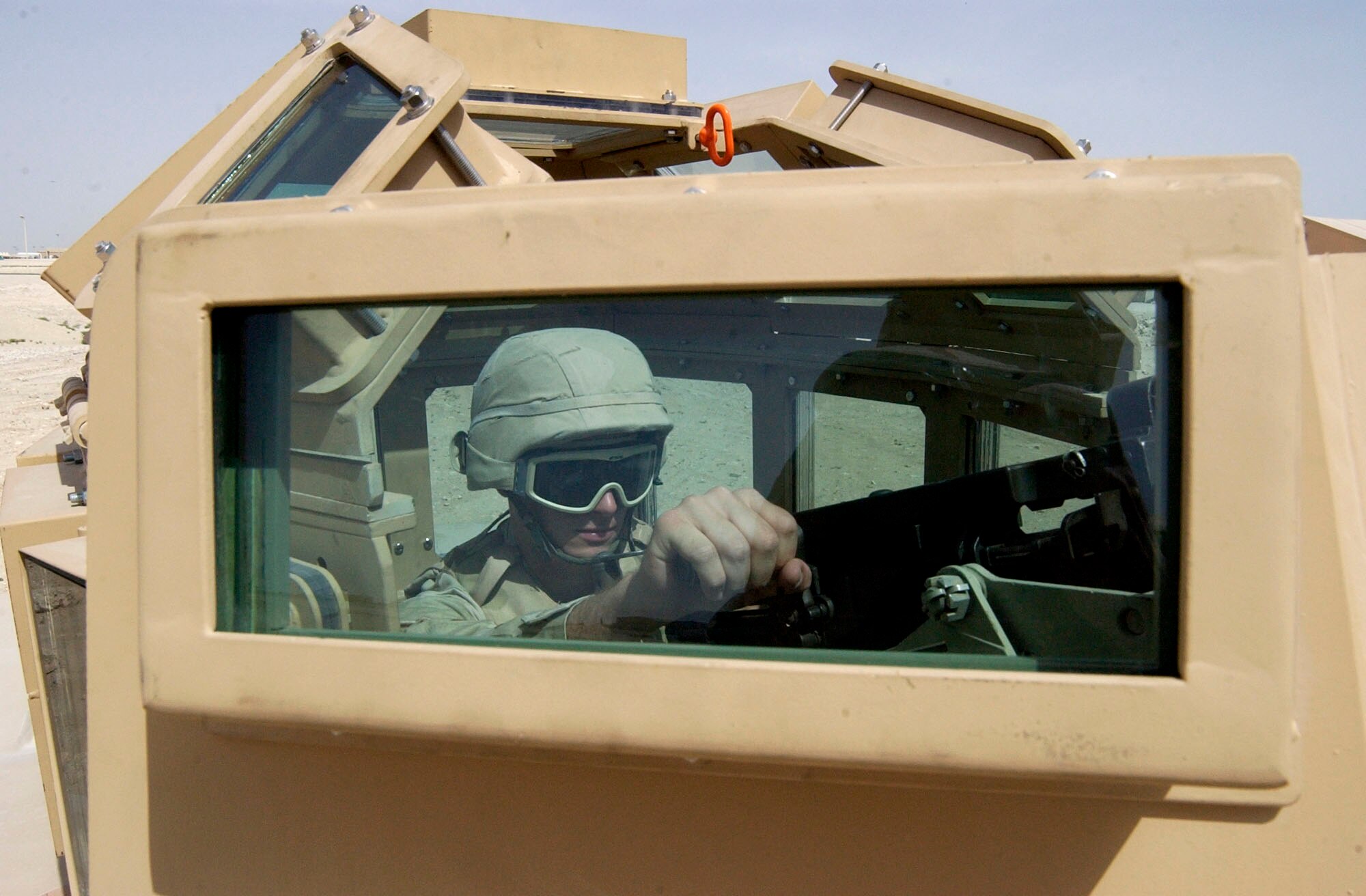 An Airman tests an improved protective turret prototype during field assessments in Southwest Asia.  The turret was developed by the USCENTAF force protection staff in concert with the Air Force Security Forces Force Protection Battlelab.  The prototype's development and testing, in less than 80 days, stemmed from the death of Airman 1st Class Leebernard Chavis, who was killed by sniper fire in October 2006.  (U.S. Air Force photo)