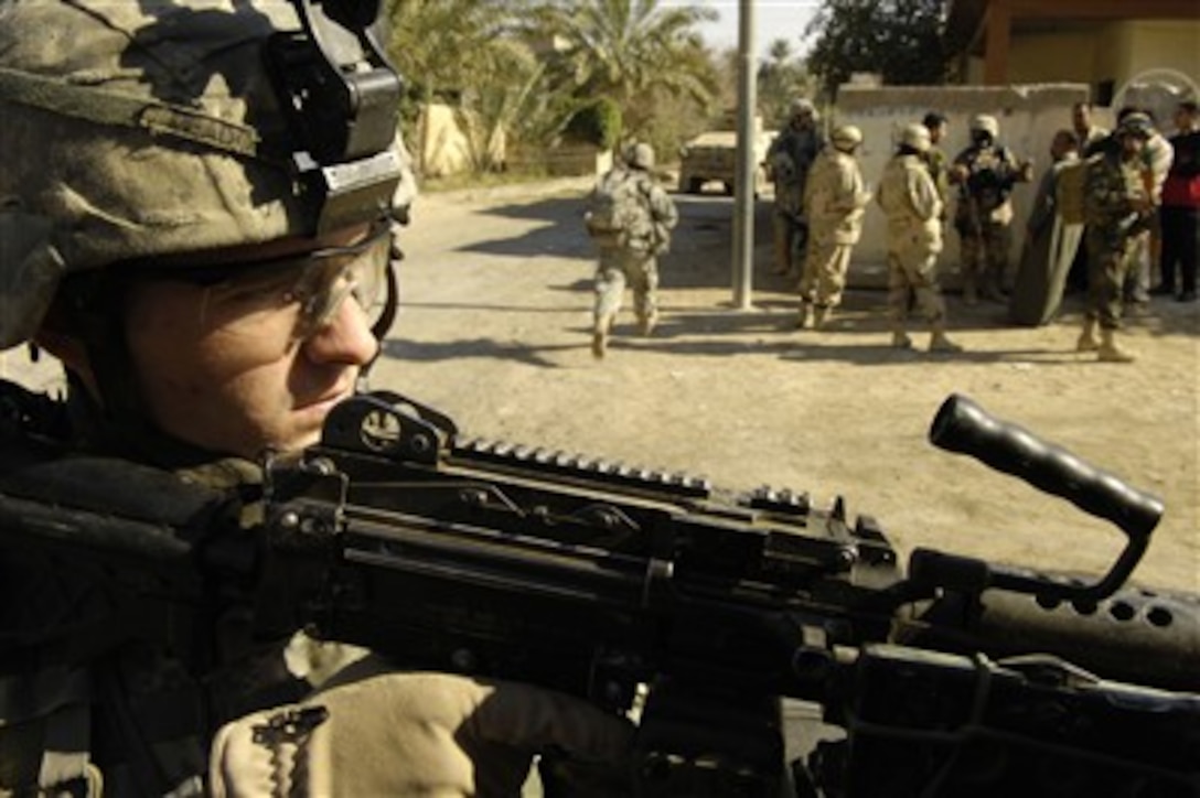 Spc. Justin Meadow keeps his weapon at the ready as he provides security for Iraqi army soldiers from the 4th Battalion, 2nd Brigade, 5th Iraqi Army Division during a joint foot patrol in Buhriz, Iraq, on Feb. 15, 2007.  Meadow is attached to the U.S. Armyís Bravo Company, 1st Cavalry Division, 12th Infantry Regiment.  