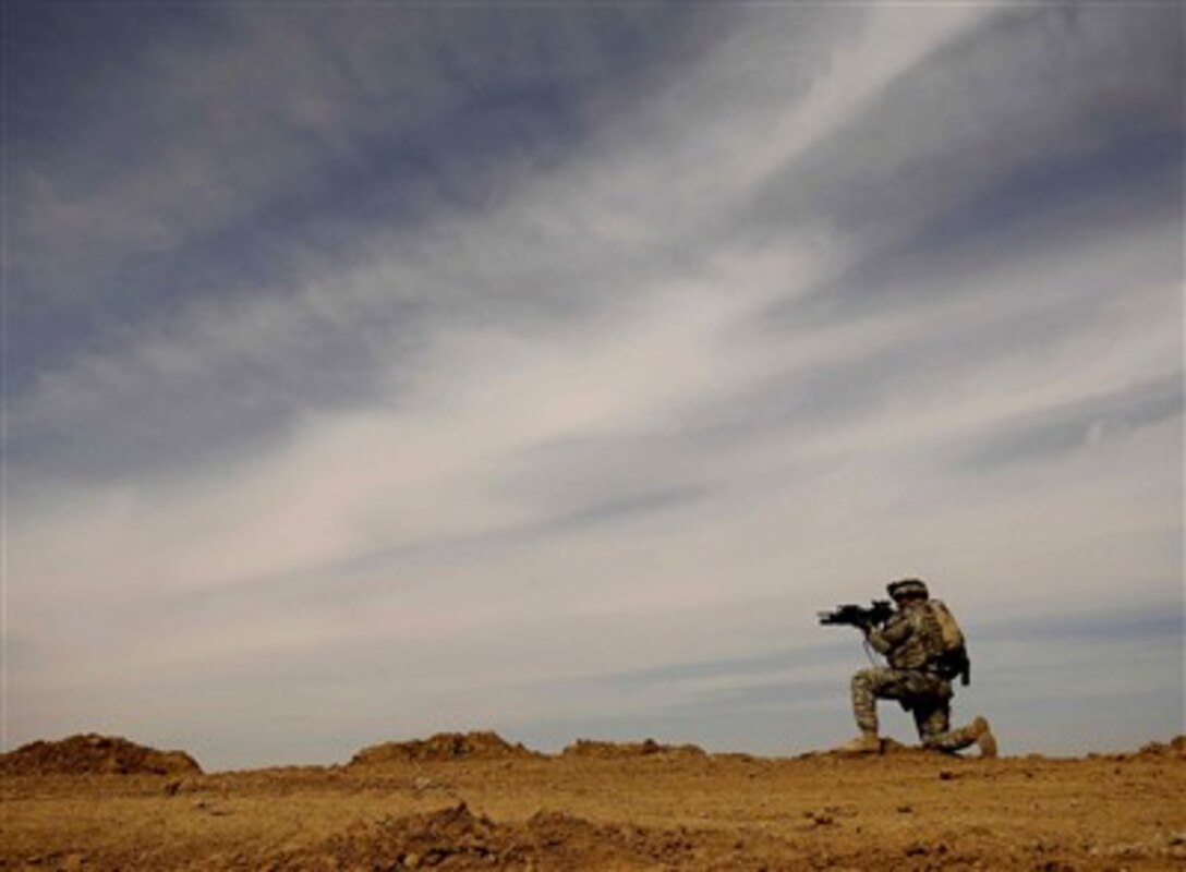 U.S. Army Sgt. Justin Walker provides security during a patrol of the Riyahd village in Iraq, March 8, 2007. 