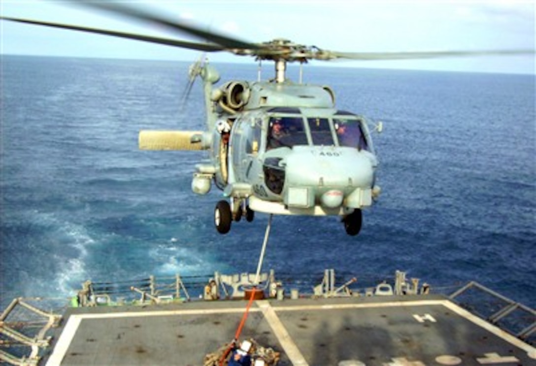 A Cutlass 460, piloted by Lt. j.g. Peter Mallory and Lt. Matt Mariano, is guided into position during a vertical replenishment with guided missile frigate USS Robert G Bradley. 