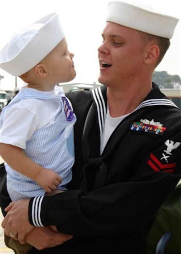 U.S. Navy Petty Officer 2nd Class Travis Baggerly embraces his son at a homecoming ceremony for the guided-missile frigate USS Taylor (FFG 50) in Mayport, Fla., on March 9, 2007.  Taylor served as scene of action commander in the Persian Gulf and assumed a central role in the security of Iraqi oil platforms.  