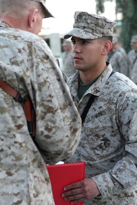 Sgt. Grady Cook assesses Pfc. Chris Minor?s simulated injuries after a mock explosion in between M and N Barracks here March 14.