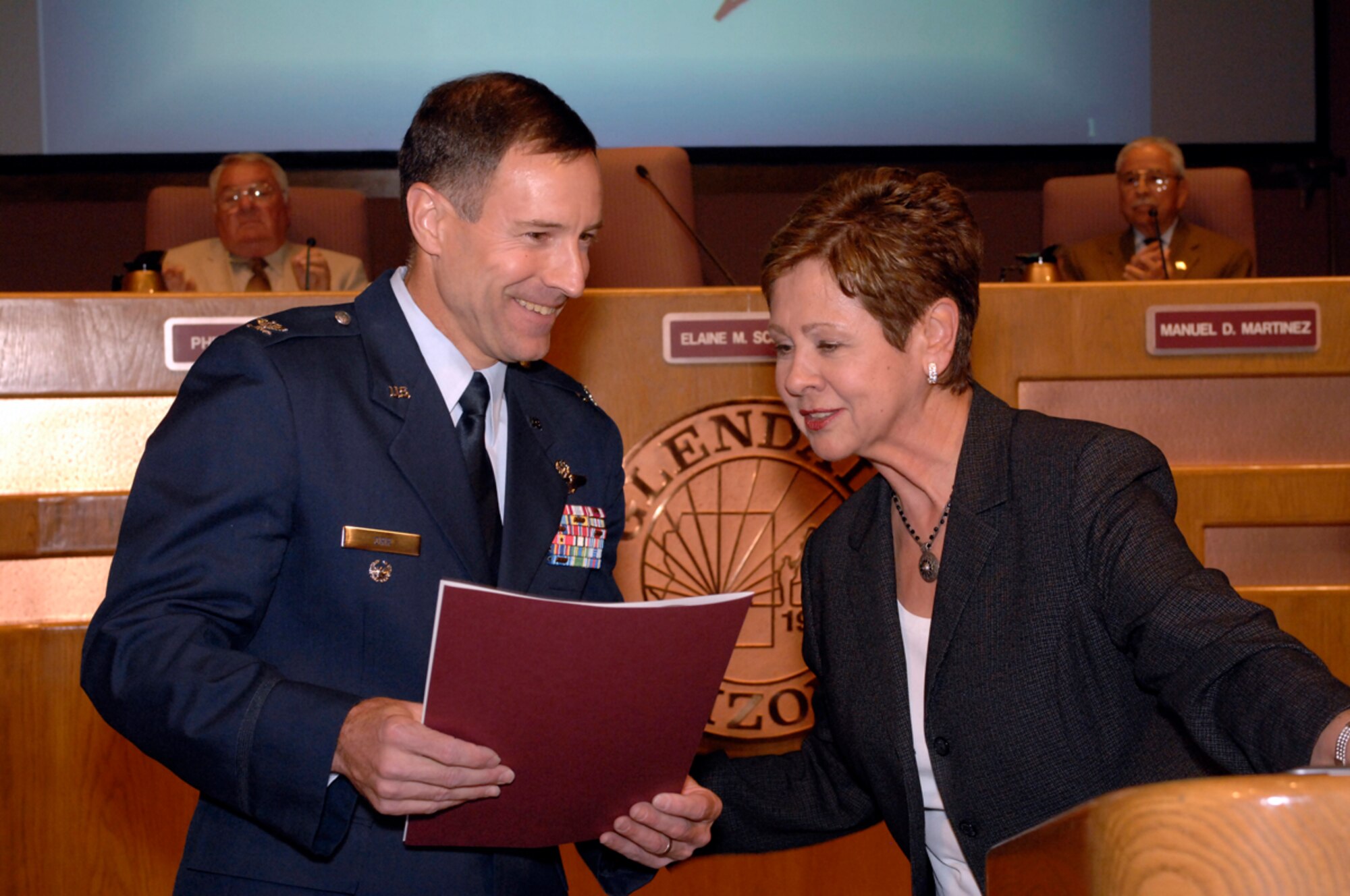 Elaine Scruggs, Glendale City mayor, presents an Air Force Week proclamation to Col. David Orr, 56th Fighter Wing vice commander at Luke Air Force Base, Ariz., in the Glendale City Council Chambers March 13. March 19 to 25 has been officially proclaimed Air Force Week by the City of Glendale. (U.S. Air Force photo/Master Sgt. William Gomez)