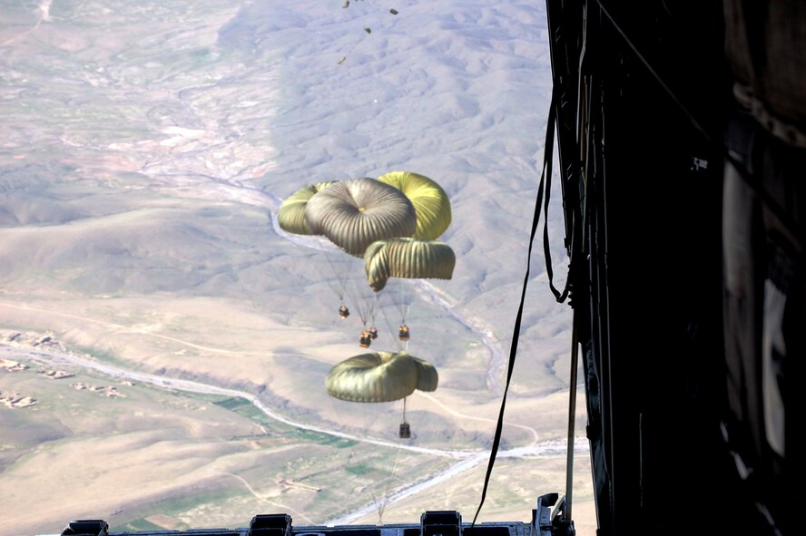 Six low-velocity chutes deliver 9,000 pounds of emergency fuel resupply to coalition ground forces engaging Taliban extremists March 13 in southern Afghanistan. The resupply landed within 35 meters of the desired drop zone. (U.S. Air Force photo) 