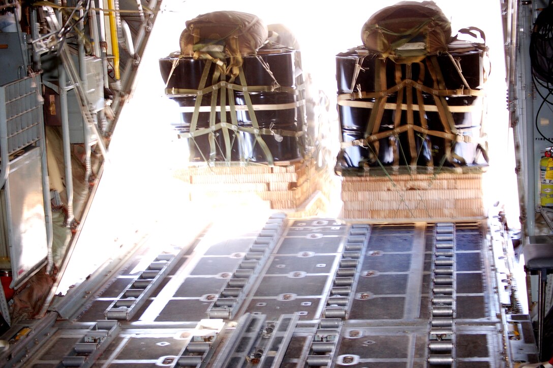Twenty-four 55-gallon drums, or 9,000 pounds of fuel, are released from a C-130 Hercules over southern Afghanistan March 13 to provide emergency resupply for coalition ground forces. The airdrop by the 774th Expeditionary Airlift Squadron from Bagram Air Base helped to sustain the combat operations of the 1st Battalion of the 508th Parachute Infantry Division against Taliban extremists. (U.S. Air Force photo) 